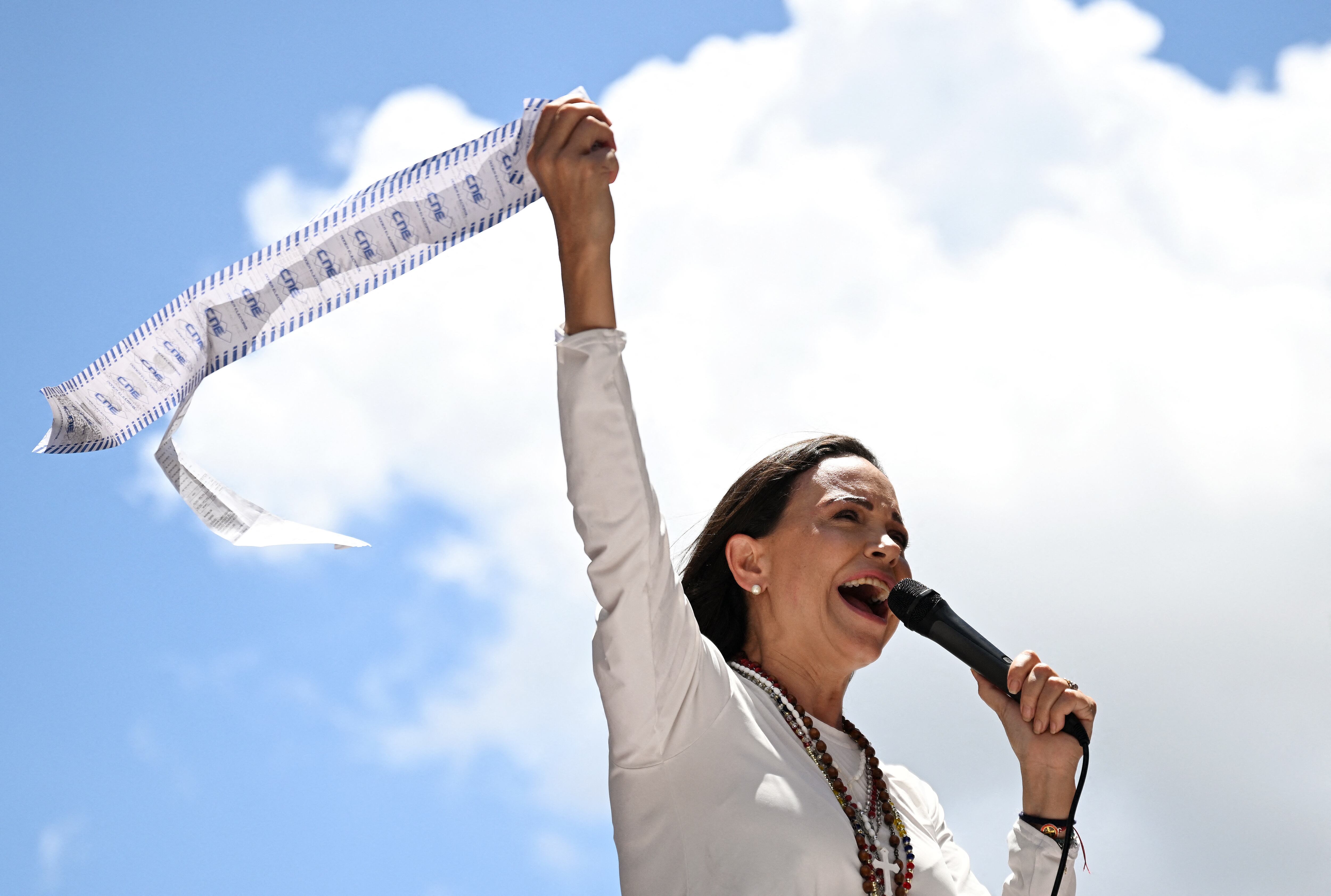 (FILES) Venezuelan opposition leader Maria Corina Machado speaks to supporters while holding up electoral records during a rally in Caracas on August 28, 2024. Venezuela opposition leader Maria Corina Machado wins the 2025 Nobel Peace Prize, the Norwegian Nobel Committee announced on October 10, 2025. (Photo by JUAN BARRETO / AFP)