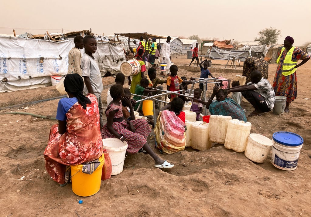 PRODUCTION - 19 March 2024, South Sudan, Renk: Refugee women from Sudan at the water point in Transit Camp 1 in the southern Sudanese border town of Renk. The bloody power struggle in Sudan, which has been ongoing since April 2023, has triggered what the UN says is the world's largest refugee crisis. More than eight million people have fled within Sudan or to neighboring countries such as South Sudan and Chad. Photo: Eva-Maria Krafczyk/dpa (Photo by Eva-Maria Krafczyk/picture alliance via Getty Images)