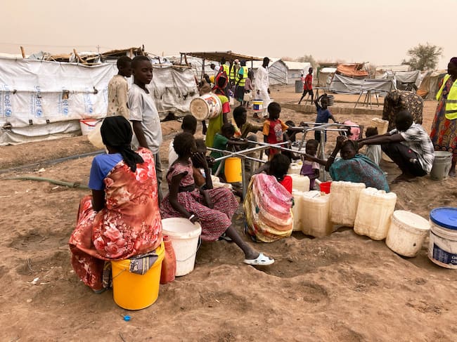 PRODUCTION - 19 March 2024, South Sudan, Renk: Refugee women from Sudan at the water point in Transit Camp 1 in the southern Sudanese border town of Renk. The bloody power struggle in Sudan, which has been ongoing since April 2023, has triggered what the UN says is the world's largest refugee crisis. More than eight million people have fled within Sudan or to neighboring countries such as South Sudan and Chad. Photo: Eva-Maria Krafczyk/dpa (Photo by Eva-Maria Krafczyk/picture alliance via Getty Images)