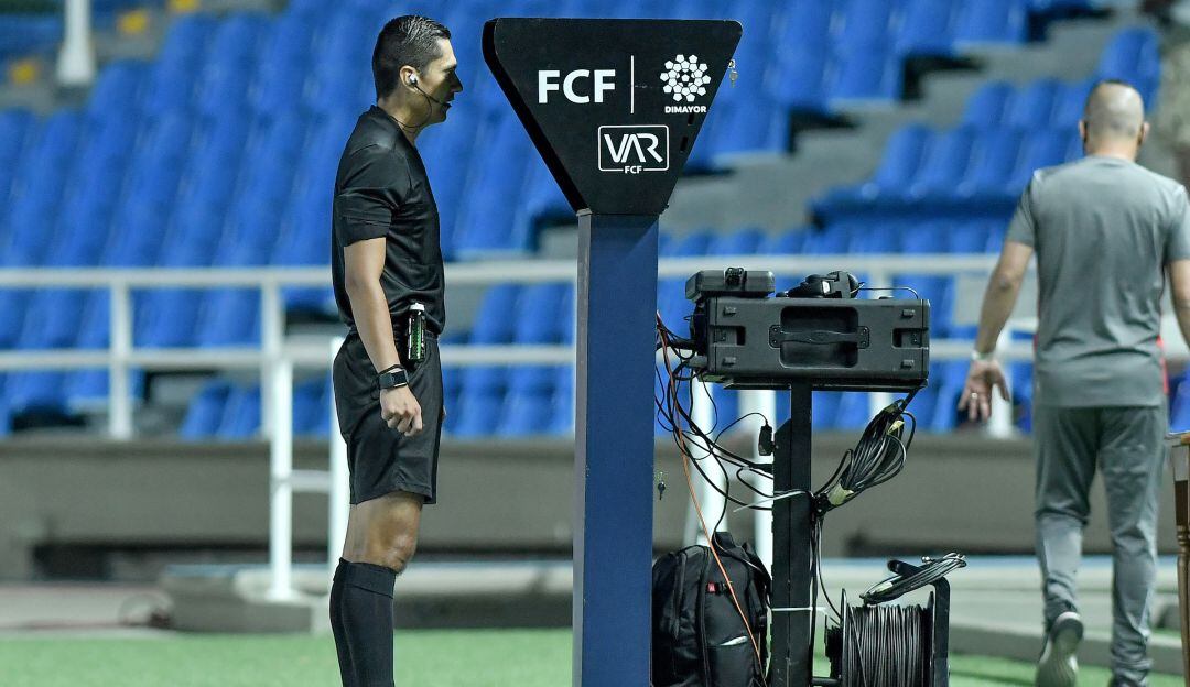 Mario Herrera revisa el VAR durante un partido de la Liga colombiana.