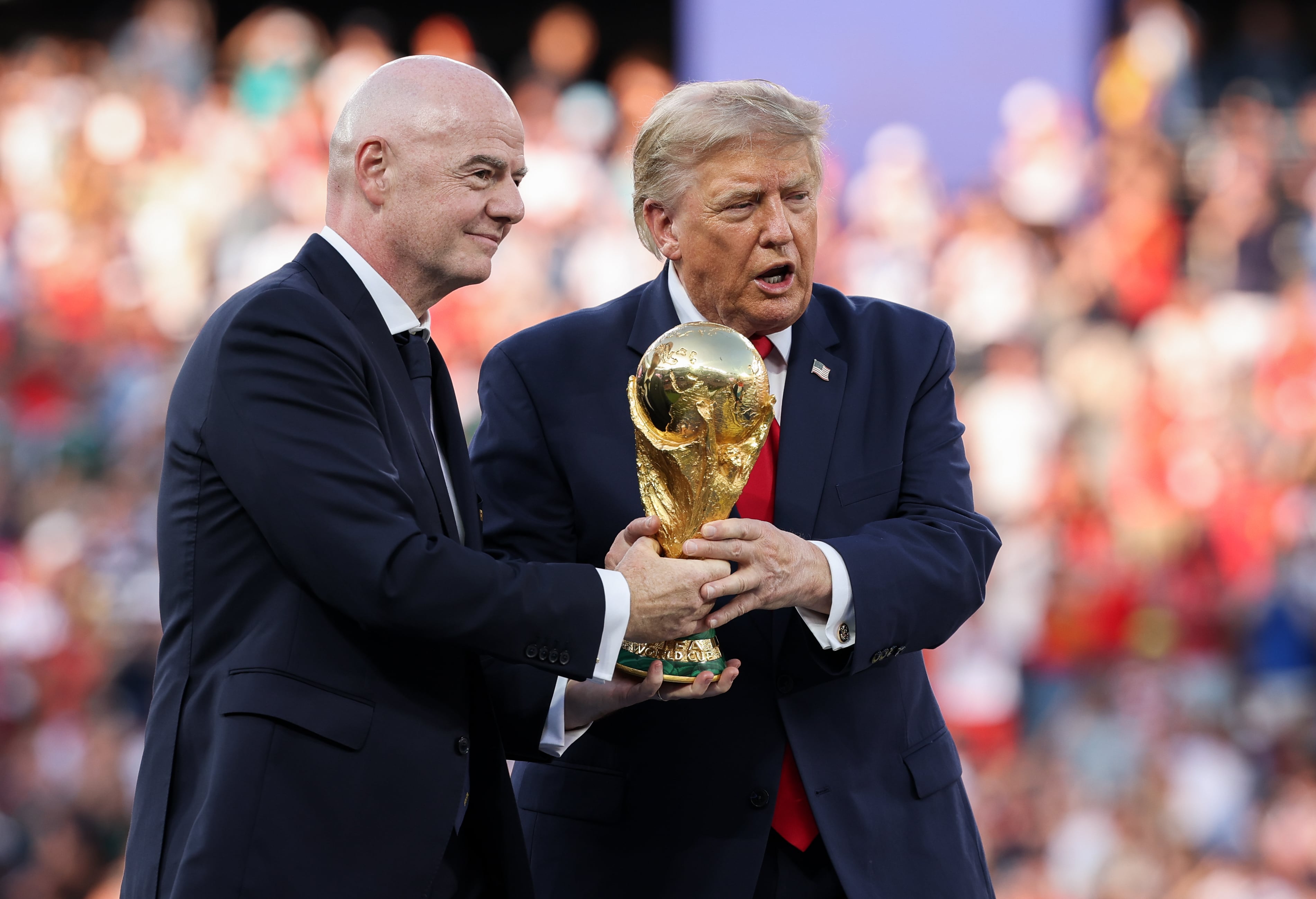 EAST RUTHERFORD, NEW JERSEY - JULY 19: U.S. President Donald Trump and FIFA President Gianni Infantino hold the FIFA World Cup Winner's Trophy before handing over to captain Rodri #16 of Spain at the award ceremony following the FIFA World Cup 2026 Final match between Spain and Argentina at New York New Jersey Stadium (Photo by Alex Pantling - FIFA/FIFA via Getty Images)