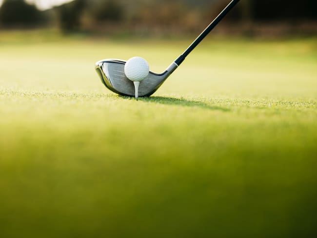 Close-Up Of Golf Ball On tee on a golf course - stock photo