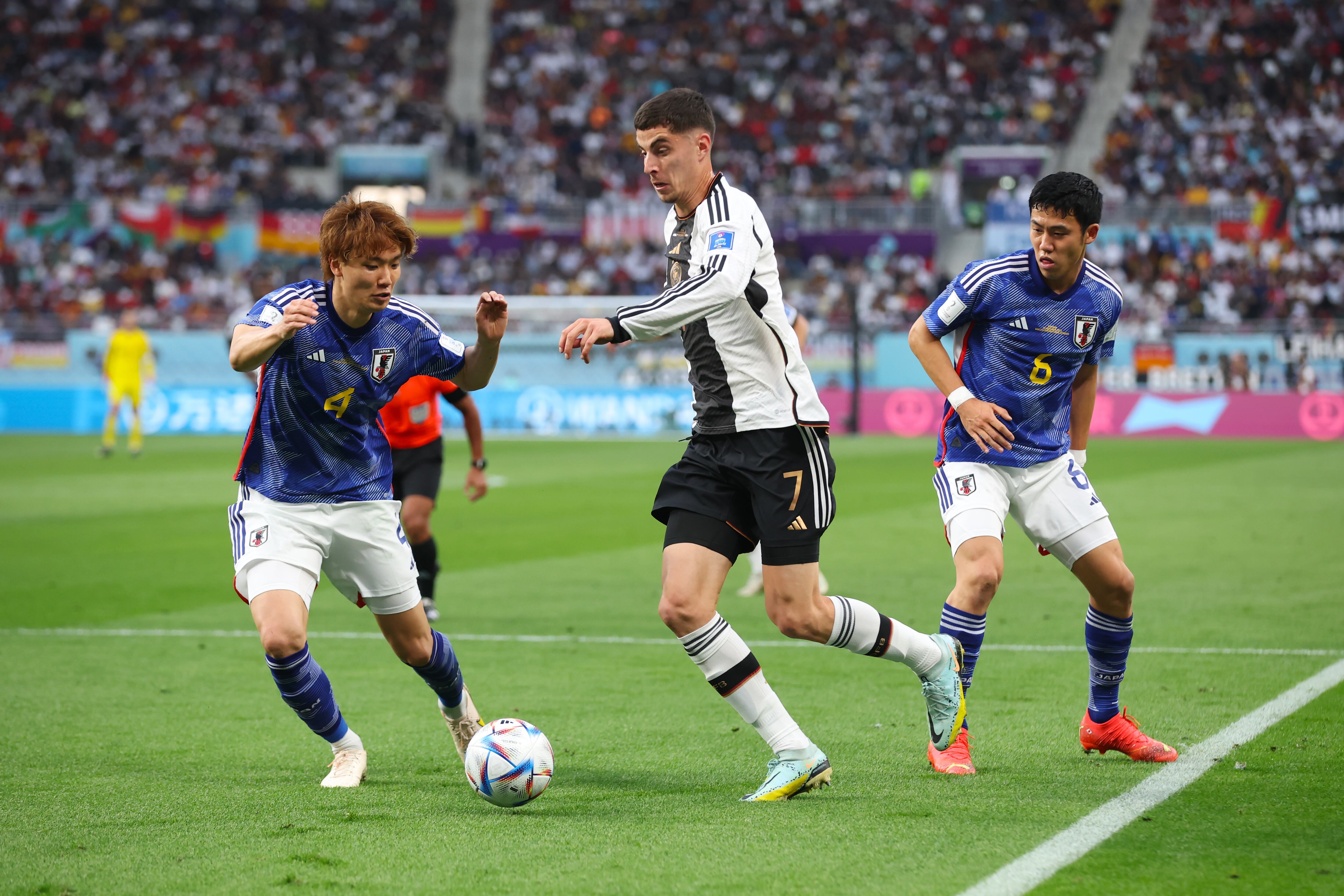 DOHA, QATAR - NOVEMBER 23: Kai Havertz of Germany battles for possession with Kou Itakura (L) and Wataru Endo of Japan during the FIFA World Cup Qatar 2022 Group E match between Germany and Japan at Khalifa International Stadium on November 23, 2022 in Doha, Qatar. (Photo by Alex Grimm/Getty Images)