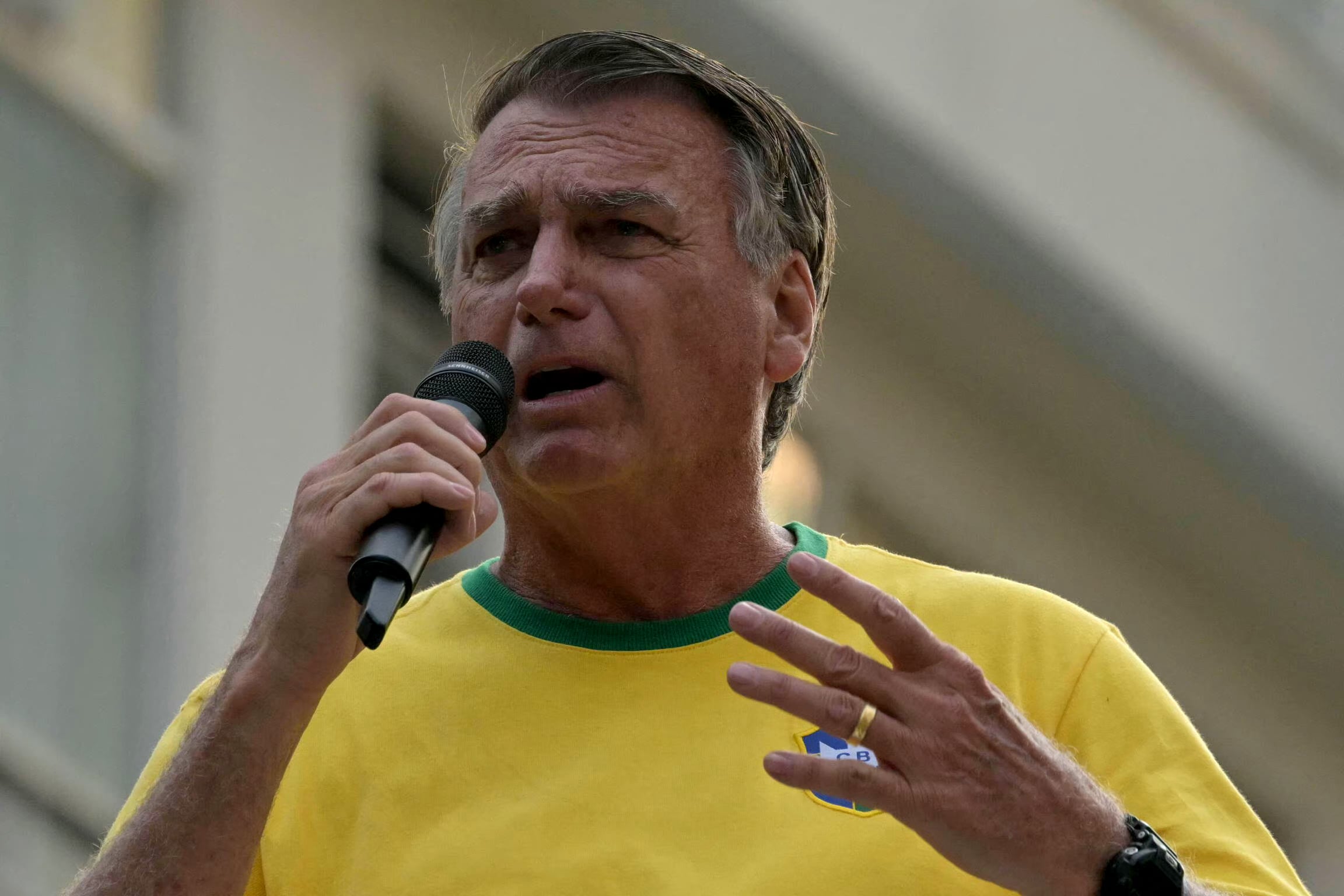 (FILES) Brazil's former President (2019-2023) Jair Bolsonaro speaks to supporters during an Independence day rally in Sao Paulo, Brazil on September 7, 2024. Bolsonaro, sentenced last September to 27 years in prison for a failed coup attempt but not yet serving his term, was taken into police custody on November 22 after trying to burn the ankle monitor tracking his house arrest, though he later claimed he acted out of �paranoia� when attempting to disable the device. (Photo by NELSON ALMEIDA / AFP)