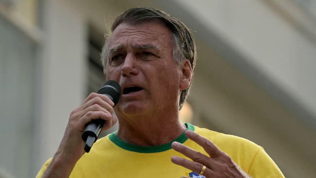 (FILES) Brazil's former President (2019-2023) Jair Bolsonaro speaks to supporters during an Independence day rally in Sao Paulo, Brazil on September 7, 2024. Bolsonaro, sentenced last September to 27 years in prison for a failed coup attempt but not yet serving his term, was taken into police custody on November 22 after trying to burn the ankle monitor tracking his house arrest, though he later claimed he acted out of �paranoia� when attempting to disable the device. (Photo by NELSON ALMEIDA / AFP)