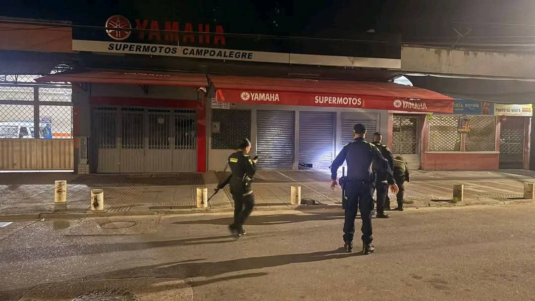 Uniformados de la Policía Huila inspeccionan el establecimiento comercial afectado por la detonación de un artefacto explosivo improvisado en Campoalegre.