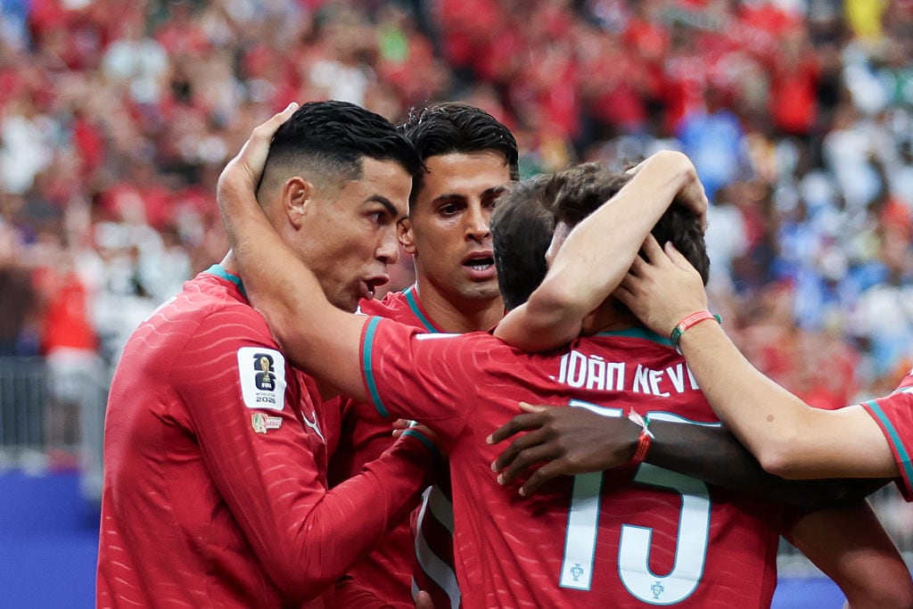 HOUSTON, UNITED STATES - 2026/06/17: Cristiano Ronaldo of Portugal (L), Joao Cancelo of Portugal (C) and Joao Neves of Portugal (R) celebrate a goal during FIFA World Cup 2026 football match between Portugal and DR Congo at NRG Stadium (Houston). Final score; Portugal 1:1 DR Congo. (Photo by Grzegorz Wajda/SOPA Images/LightRocket via Getty Images)