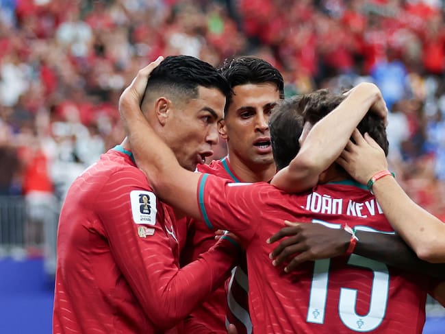 HOUSTON, UNITED STATES - 2026/06/17: Cristiano Ronaldo of Portugal (L), Joao Cancelo of Portugal (C) and Joao Neves of Portugal (R) celebrate a goal during FIFA World Cup 2026 football match between Portugal and DR Congo at NRG Stadium (Houston). Final score; Portugal 1:1 DR Congo. (Photo by Grzegorz Wajda/SOPA Images/LightRocket via Getty Images)