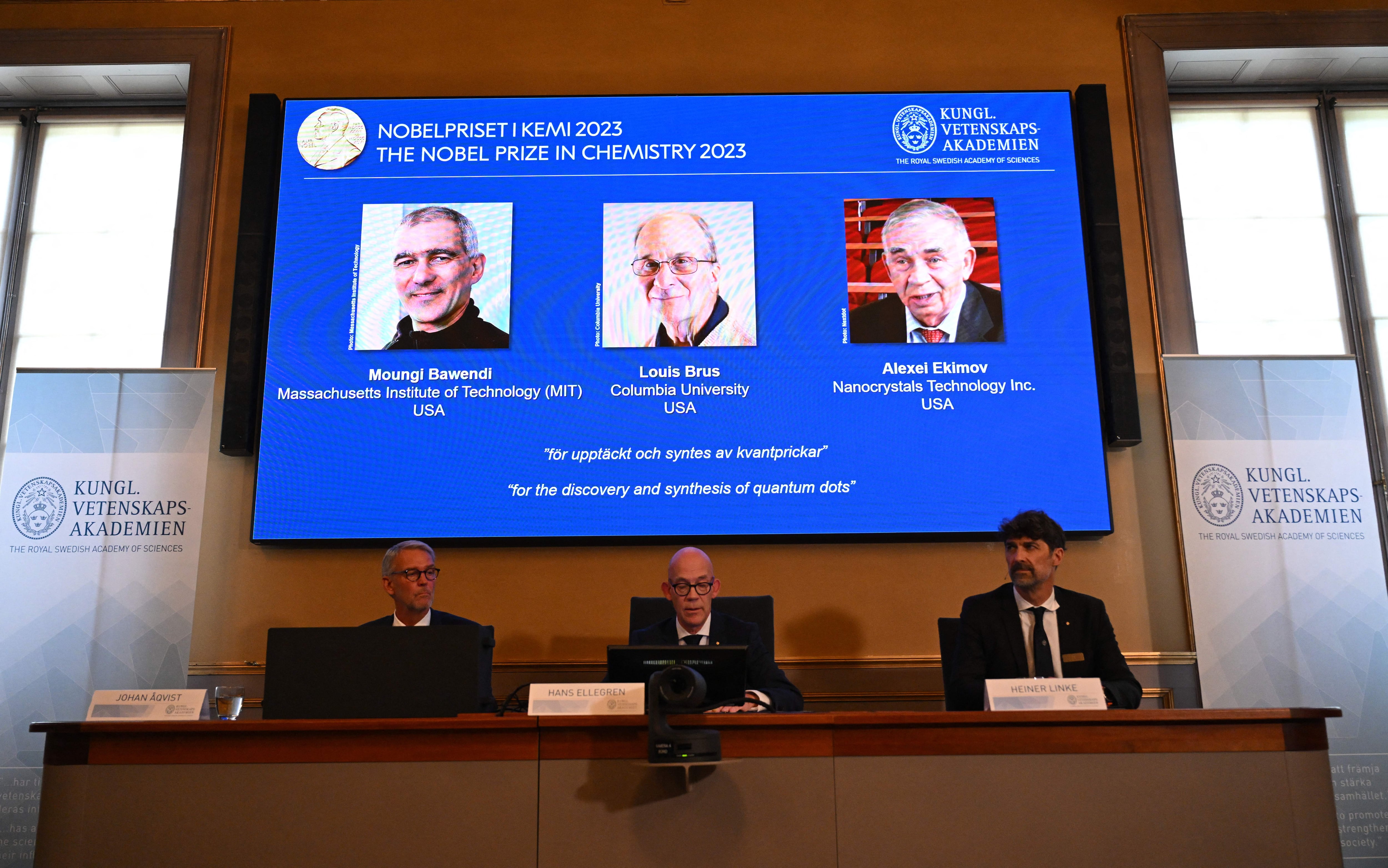 A screen shows this year's laureates US Chemist Moungi Bawendi, US Chemist Louis Brus and Russian physicist Alexei Ekimov during the announcement of the winners of the 2023 Nobel Prize in chemistry at Royal Swedish Academy of Sciences in Stockholm on October 4, 2023. The trio, whose names were leaked in the Swedish press ahead of the announcement, succeeded in producing these tiny components, that "now spread their light from televisions and LED lamps, and can also guide surgeons when they remove tumour tissue, among many other things," the jury said. (Photo by Jonathan NACKSTRAND / AFP) (Photo by JONATHAN NACKSTRAND/AFP via Getty Images)