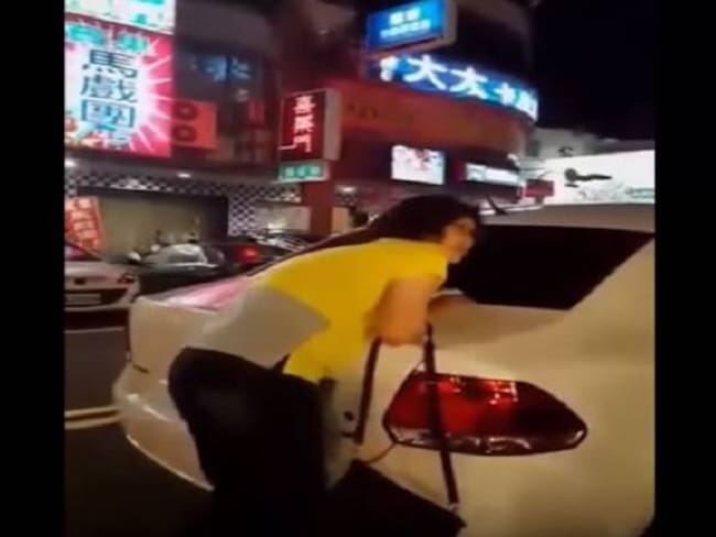 Mujer se aferra a su auto para evitar que sea llevado por la grúa