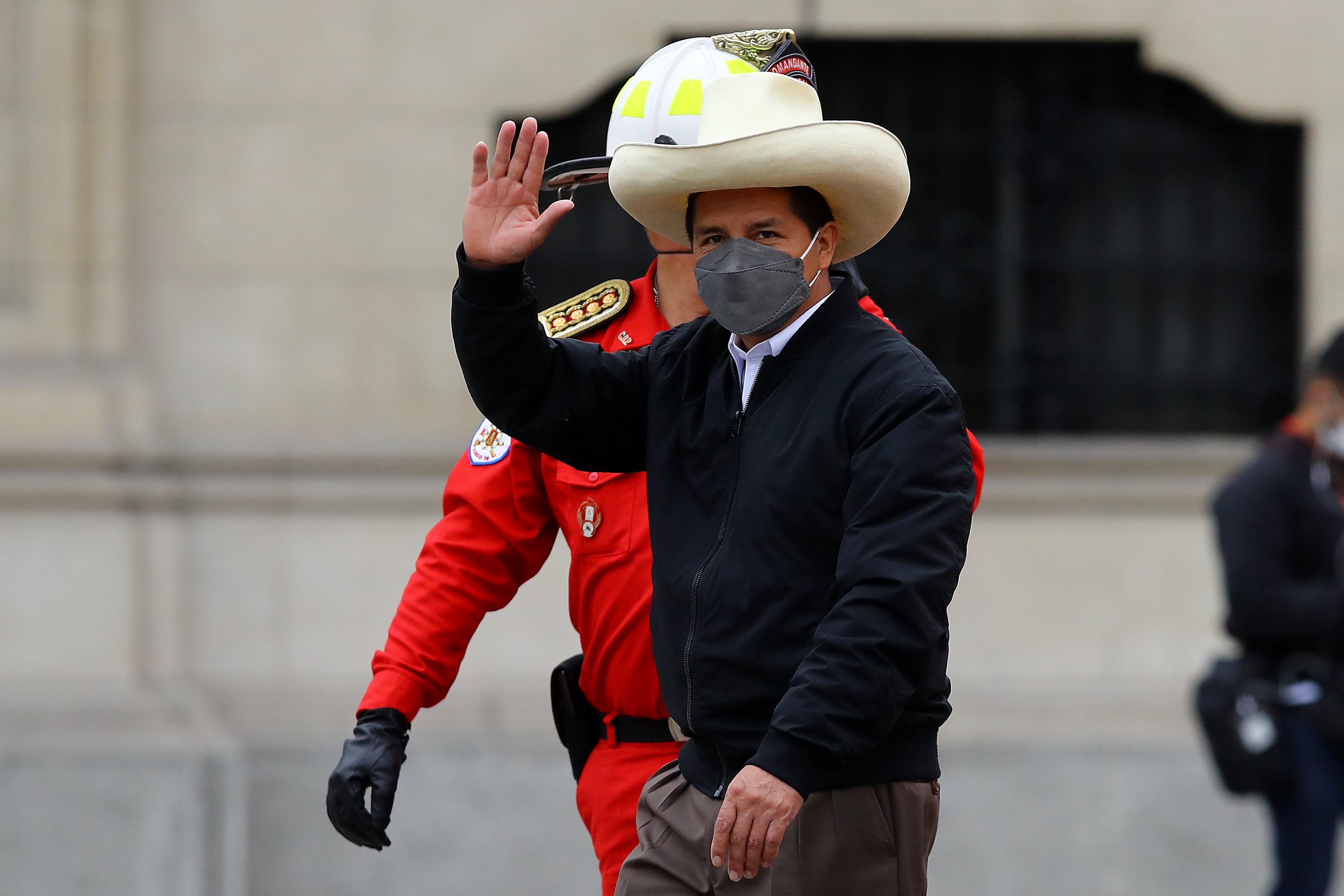 LIMA, PERU - DECEMBER 05: Peruvian President Pedro Castillo salutes during an event to deliver firetrucks to Volunteer firefighters of Peru on December 5, 2021 in Lima, Peru. After only four months in power, National Congress will vote this week on whether to start the formal impeachment process to Castillo. The Left-wing President will also be questioned by prosecutors on December 14th over promotions for military officers. (Photo by Leonardo Fernandez/Getty Images)