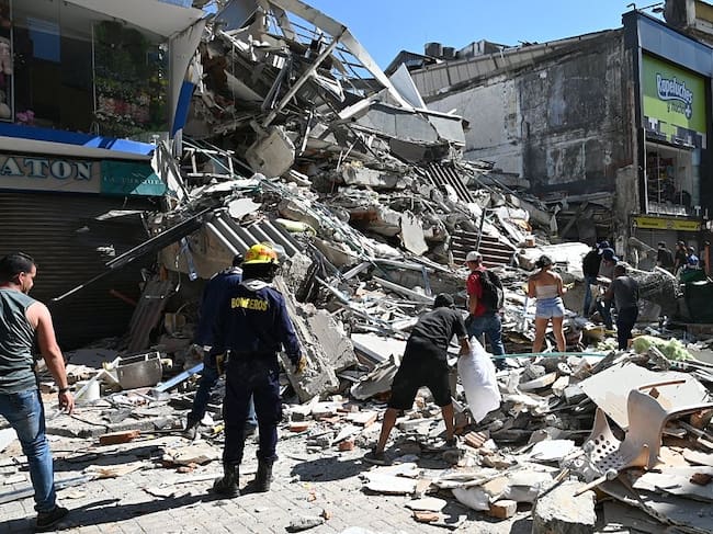 PEREIRA, COLOMBIA - AUGUST 10: Residents and rescue workers carry out search, rescue and evacuation operations after a powerful earthquake struck Colombia, killing at least 18 people and causing widespread damage in Pereira, on August 10, 2026 in Pereira, Colombia. Preliminary reports indicate that several structures collapsed, buildings and roads were damaged, and some public services were temporarily disrupted. Hospitals activated emergency plans to treat the injured, while technical teams began assessing damaged buildings as authorities warned residents to avoid unsafe structures and remain alert for aftershocks. (Photo by Alexis Munera/Anadolu via Getty Images)