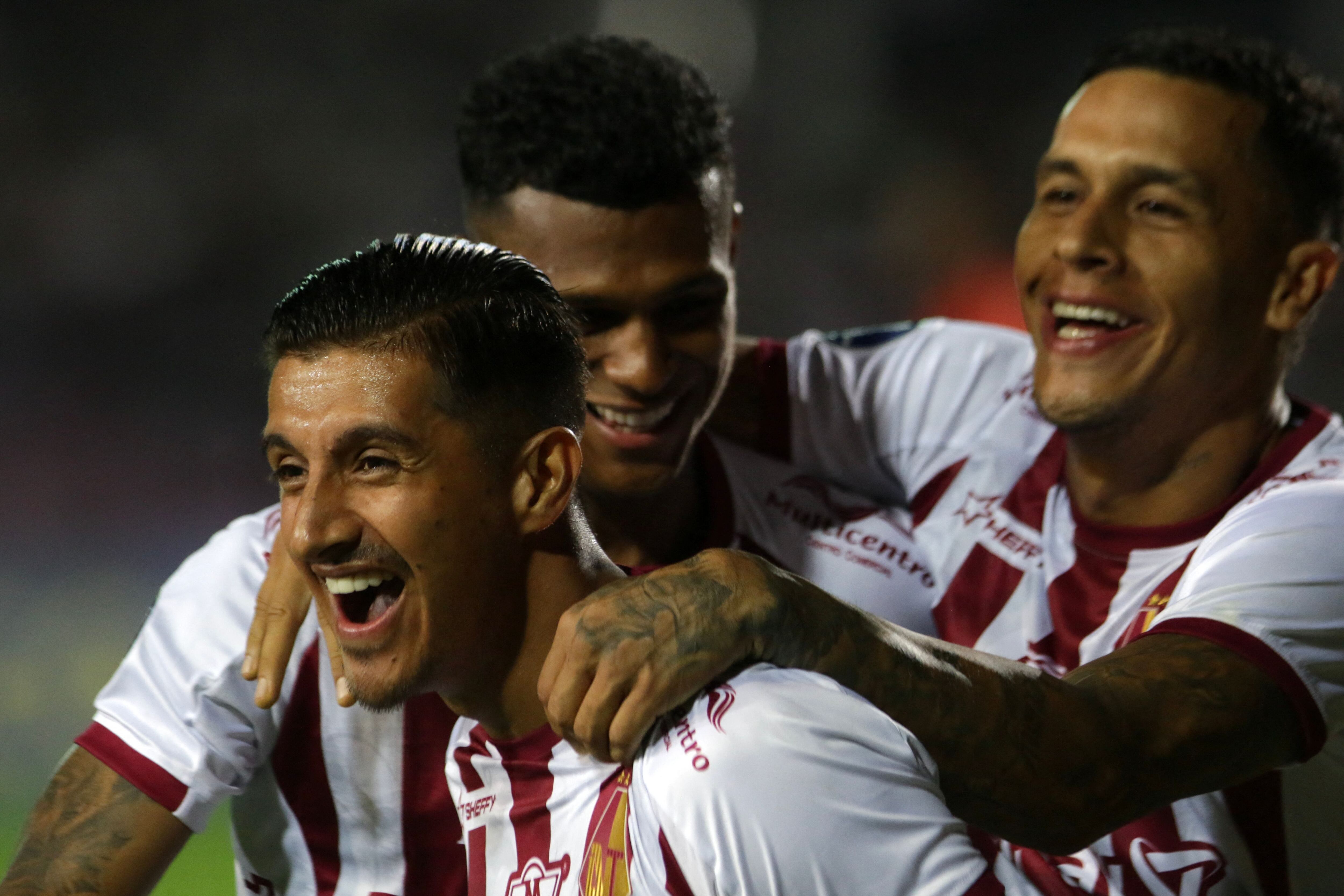 Tolima's midfielder Yeison Guzman (L) celebrates with teammates after scoring during the Copa Sudamericana group stage first leg football match between Puerto Cabello and Deportes Tolima at the Misael Delgado stadium in Valencia, Venezuela on April 6, 2023. (Photo by Juan Carlos HERNANDEZ / AFP) (Photo by JUAN CARLOS HERNANDEZ/AFP via Getty Images)