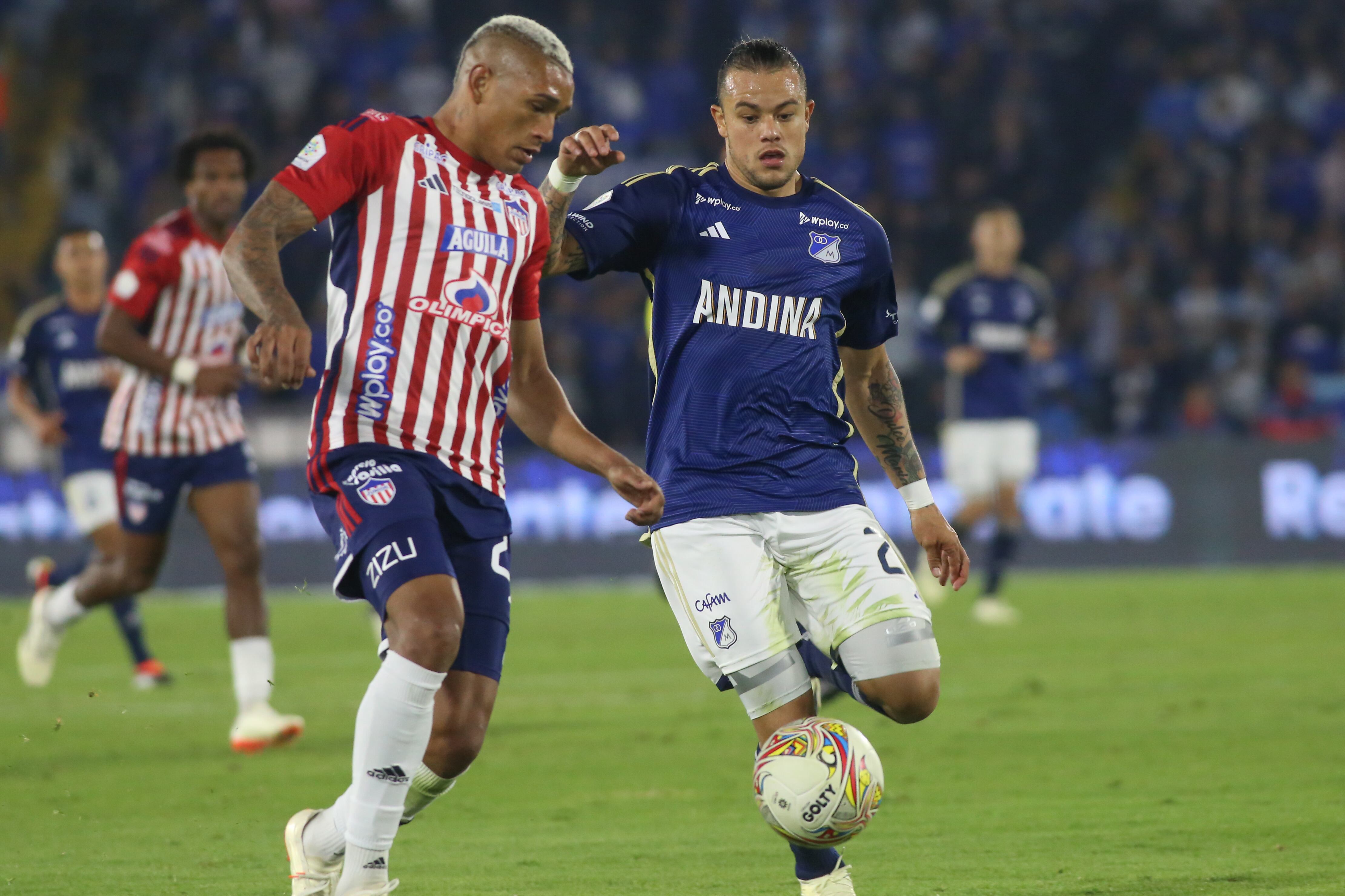 Leonardo Castro of Millonarios F.C. and Jermein Pena of Atletico Junior are fighting for the ball during the match on date 17 for the BetPlay DIMAYOR I 2024 League, played at the Nemesio Camacho El Campin Stadium in Bogota, Colombia. (Photo by Daniel Garzon Herazo/NurPhoto via Getty Images)