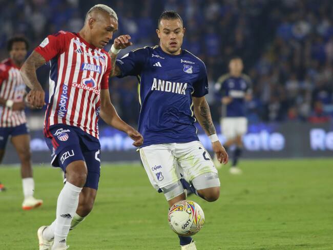 Leonardo Castro of Millonarios F.C. and Jermein Pena of Atletico Junior are fighting for the ball during the match on date 17 for the BetPlay DIMAYOR I 2024 League, played at the Nemesio Camacho El Campin Stadium in Bogota, Colombia. (Photo by Daniel Garzon Herazo/NurPhoto via Getty Images)