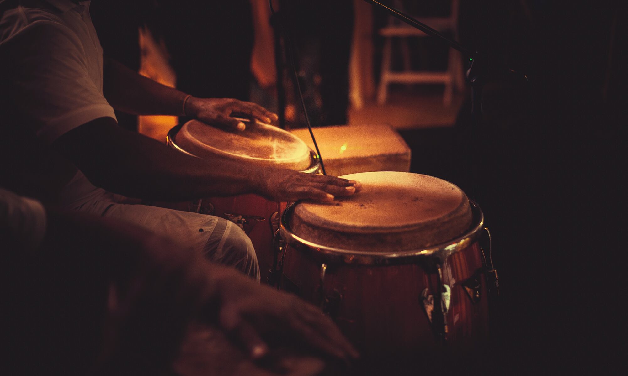 detail of hands playing latin percussion (tumbadora or congas)