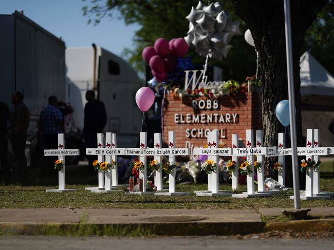 Crosses sit outside the Robb Elementary School in remembrance of those killed on Thursday, in Uvalde, Texas on May 26, 2022. - Grief at the massacre of 19 children at the elementary school in Texas spilled into confrontation on May 25, as angry questions mounted over gun control -- and whether this latest tragedy could have been prevented. The tight-knit Latino community of Uvalde on May 24 became the site of the worst school shooting in a decade, committed by a disturbed 18-year-old armed with a legally bought assault rifle. (Photo by allison dinner / AFP) (Photo by ALLISON DINNER/AFP via Getty Images)