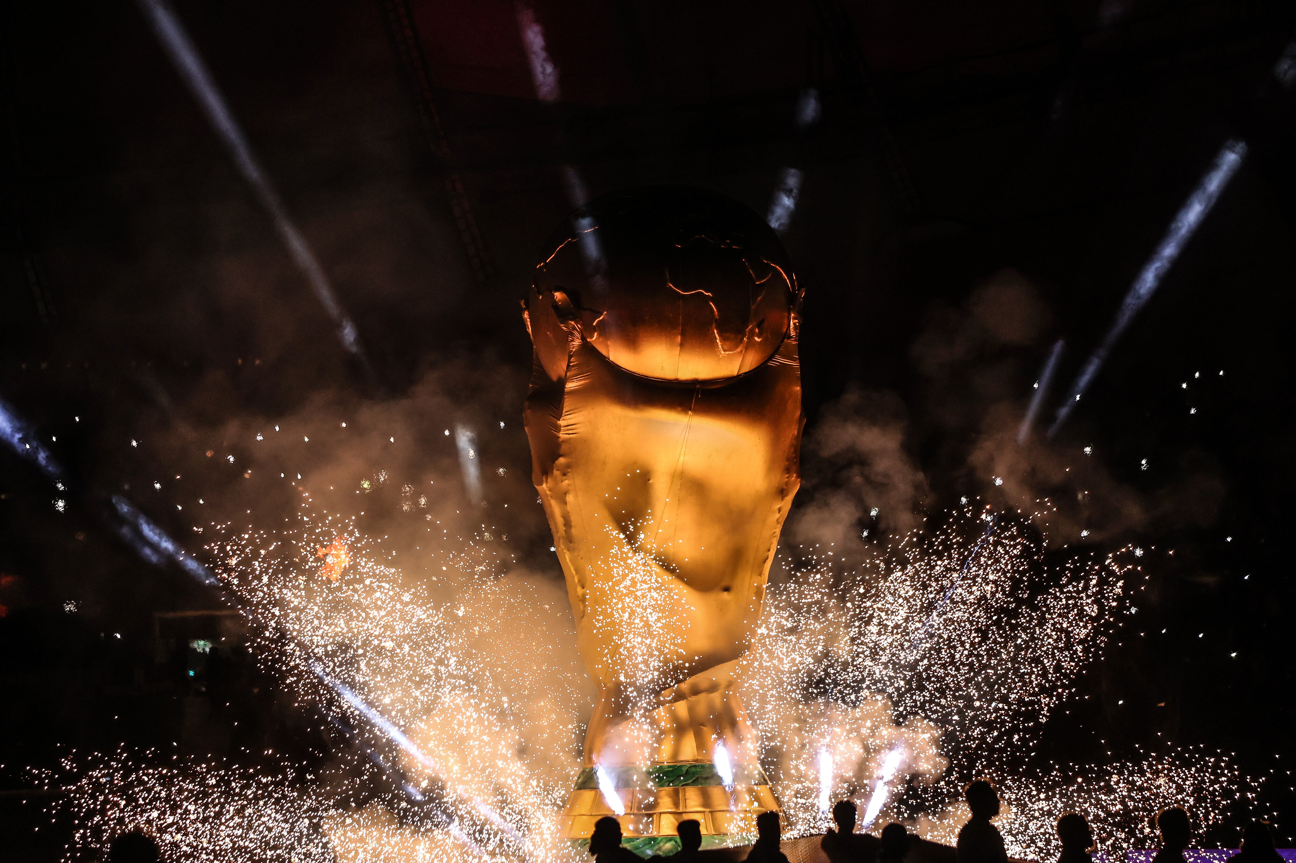 DOHA, QATAR - DECEMBER 01:  A giant inflatable replica of the FIFA World Cup trophy is seen surround by fireworks during the FIFA World Cup Qatar 2022 Group E match between Japan and Spain at Khalifa International Stadium on December 1, 2022 in Doha, Qatar. (Photo by Marc Atkins/Getty Images)