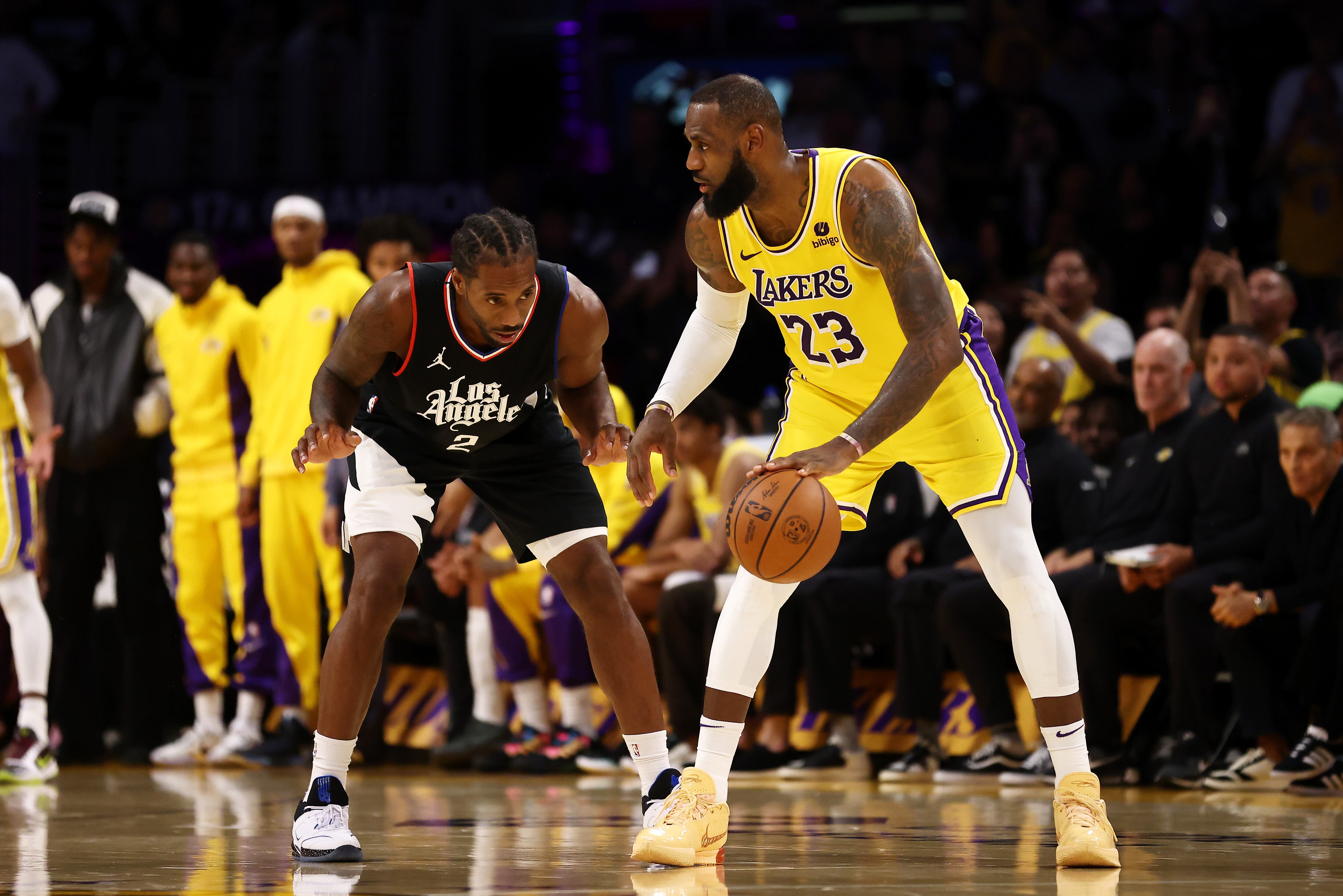 LOS ANGELES, CALIFORNIA - NOVEMBER 01: LeBron James #23 of the Los Angeles Lakers dribbles the ball against Kawhi Leonard #2 of the Los Angeles Clippers during the fourth quarter at Crypto.com Arena on November 01, 2023 in Los Angeles, California. NOTE TO USER: User expressly acknowledges and agrees that, by downloading and or using this photograph, User is consenting to the terms and conditions of the Getty Images License Agreement. (Photo by Katelyn Mulcahy/Getty Images)