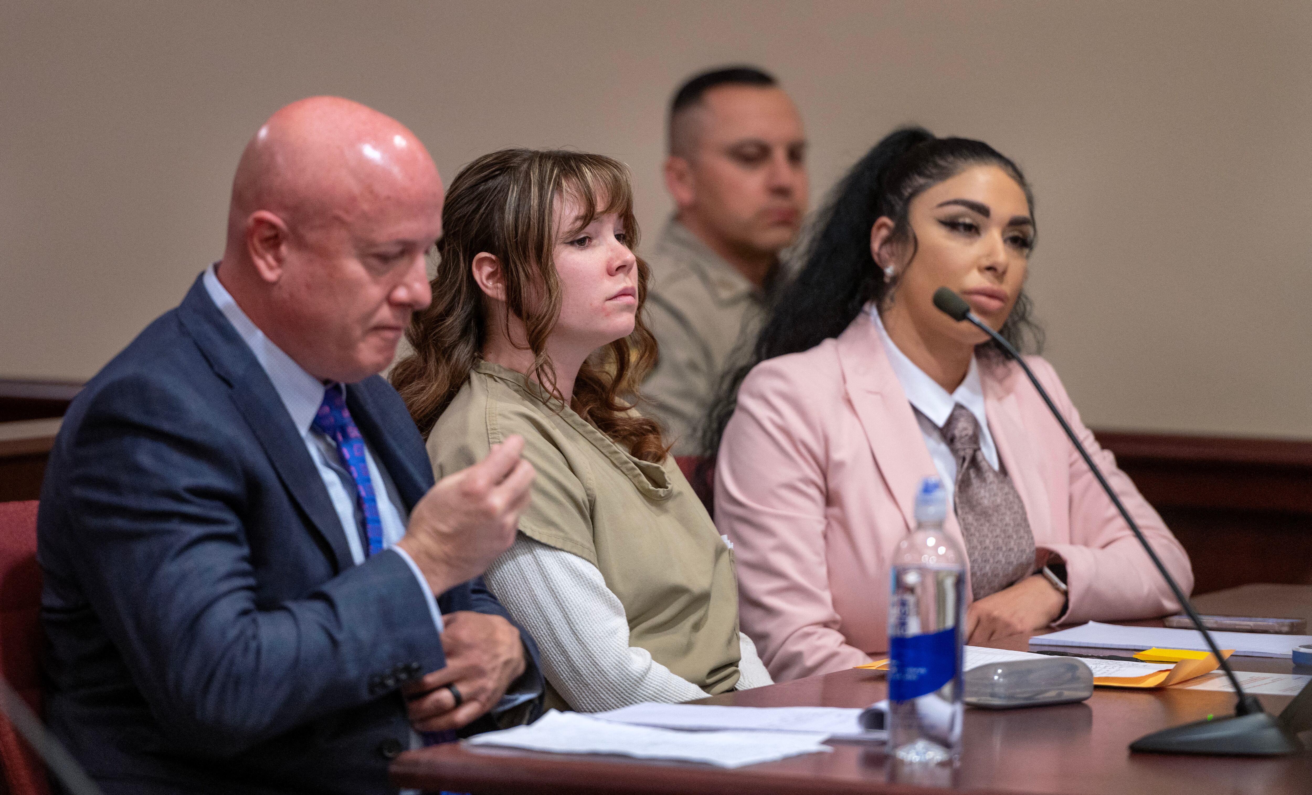Hannah Gutierrez-Reed (C), the former armorer at the movie Rust, attends her sentencing hearing with attorney Jason Bowles (L) and paralegal Carmella Sisneros (R) at the First Judicial District Courthouse in Santa Fe, New Mexico, April 15, 2024. - The armorer who loaded the gun that killed a cinematographer on the set of the Alec Baldwin movie "Rust" was convicted March 6, 2024 of involuntary manslaughter. A jury in New Mexico took just over two hours to find Hannah Gutierrez guilty over the death of Halyna Hutchins in October 2021 during filming of the budget Western. (Photo by Eddie Moore / Journal / POOL / AFP)