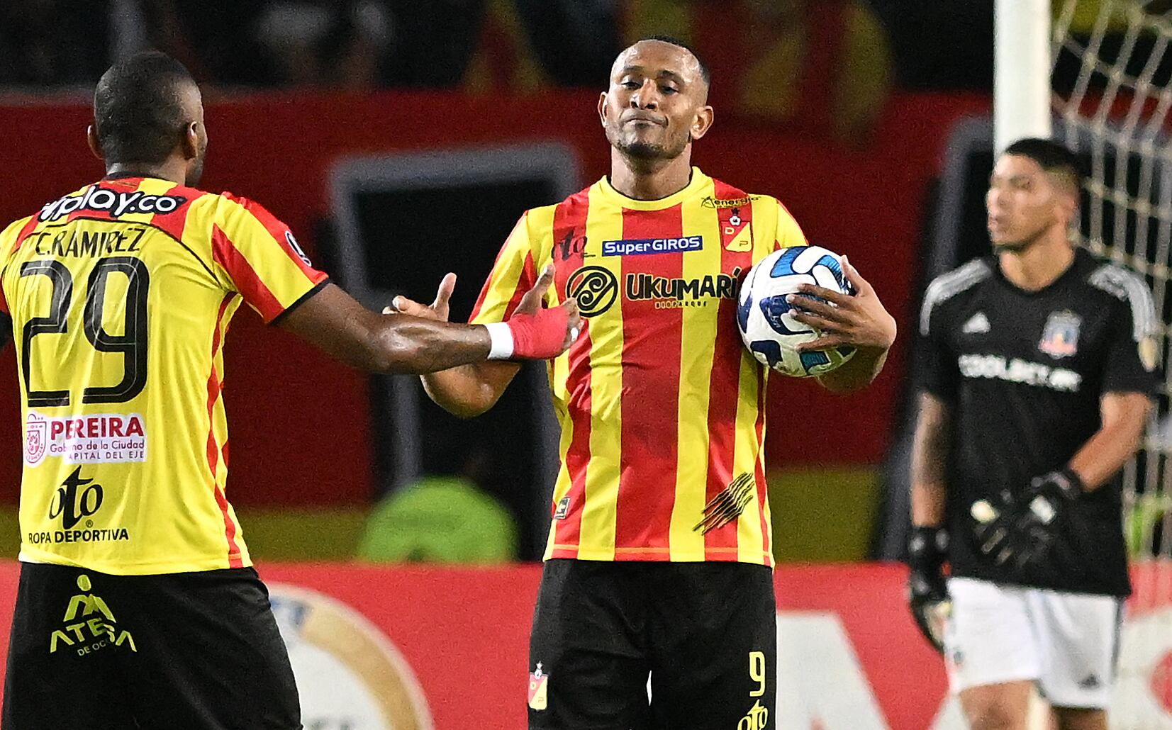 Deportivo Pereira's forward Angelo Rodriguez (C) celebrates with defender Carlos Ramirez after scoring a goal during the Copa Libertadores group stage first leg football match between Deportivo Pereira and Colo Colo, at the Hernán Ramírez Villegas stadium in Pereira, Colombia, on April 5, 2023. (Photo by JOAQUIN SARMIENTO / AFP) (Photo by JOAQUIN SARMIENTO/AFP via Getty Images)