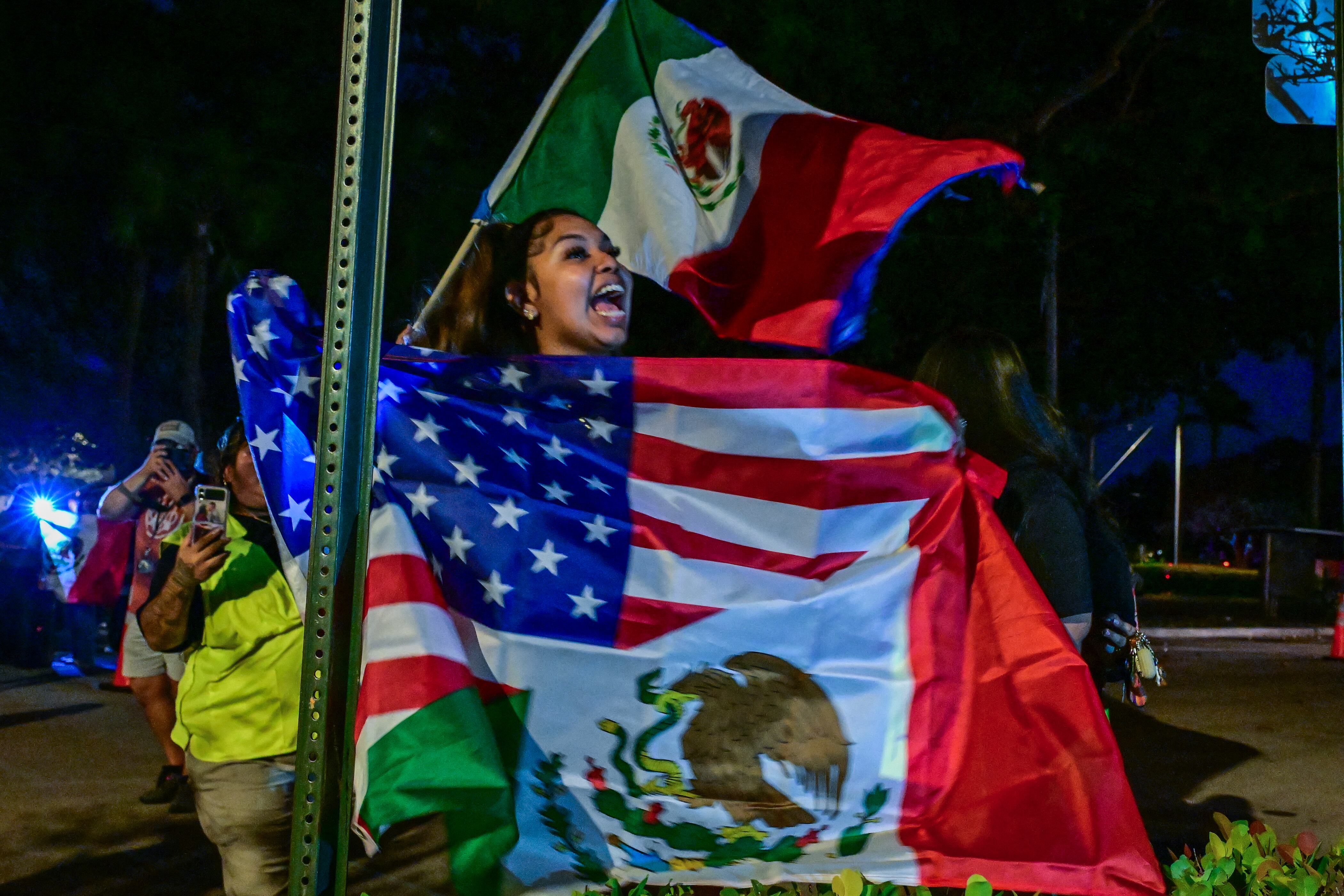 Demonstrators take part in the "Latinos Unidos" protest against mass deportations and the immigration policies of US President Donald Trump, in Lake Worth Beach, Florida, on February 7, 2025. (Photo by Giorgio VIERA / AFP)