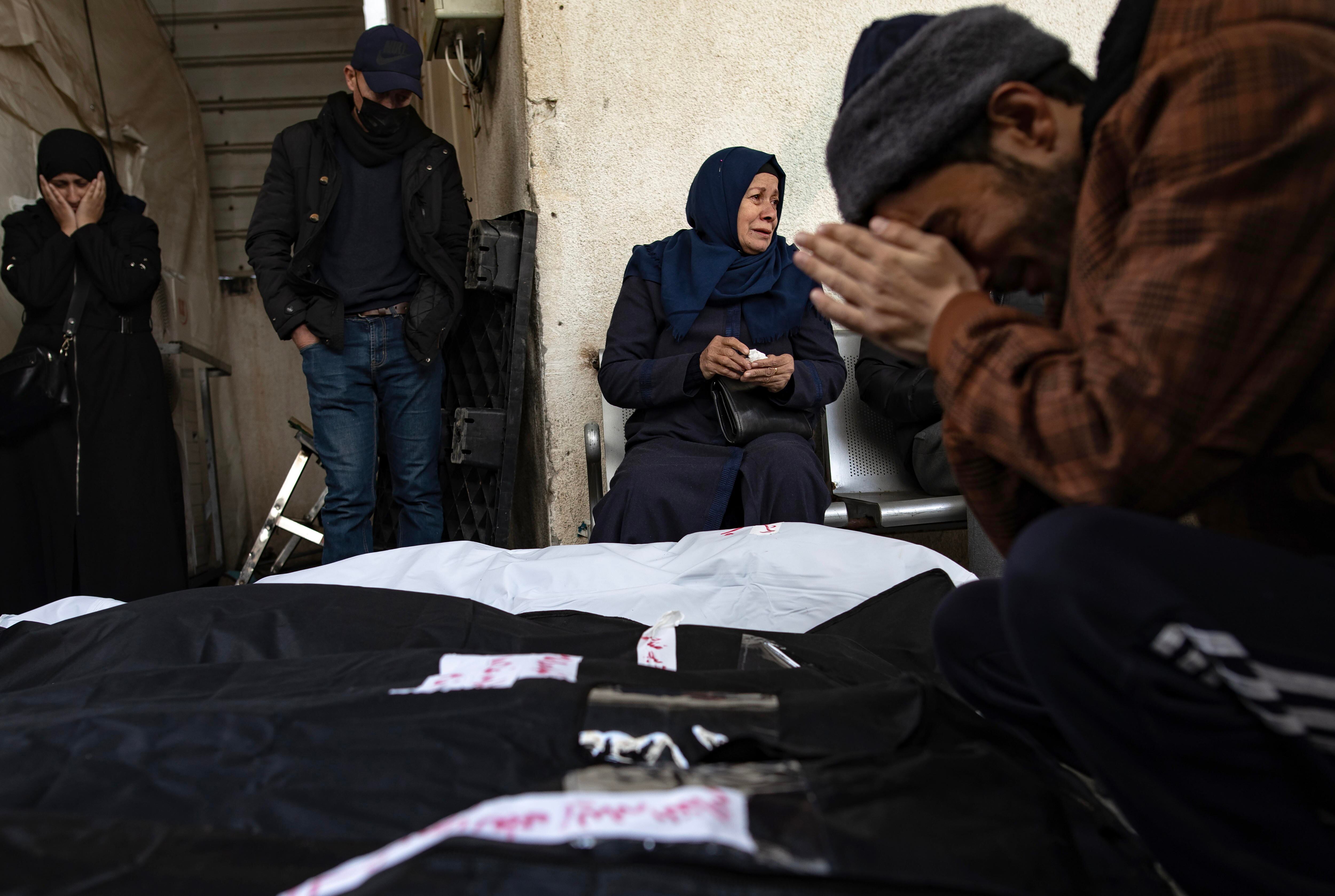 Gaza (---), 10/02/2024.- Palestinians from the Ghannam family sit next to the wrapped bodies of some of their relatives who were killed following an Isareili airstrike on Rafah refugee camp, inside Al-Najjar Hospital, Rafah, southern Gaza Strip, 10 February 2024. Israel's Prime Minister Netanyahu on 09 February ordered the Israeli military to present a plan of evacuation of Palestinians from Rafah. Nearly 28,000 Palestinians and over 1,300 Israelis have been killed, according to the Palestinian Health Ministry and the Israel Defense Forces (IDF), since Hamas militants launched an attack against Israel from the Gaza Strip on 07 October 2023, and the Israeli operations in Gaza and the West Bank which followed it. EFE/EPA/HAITHAM IMAD