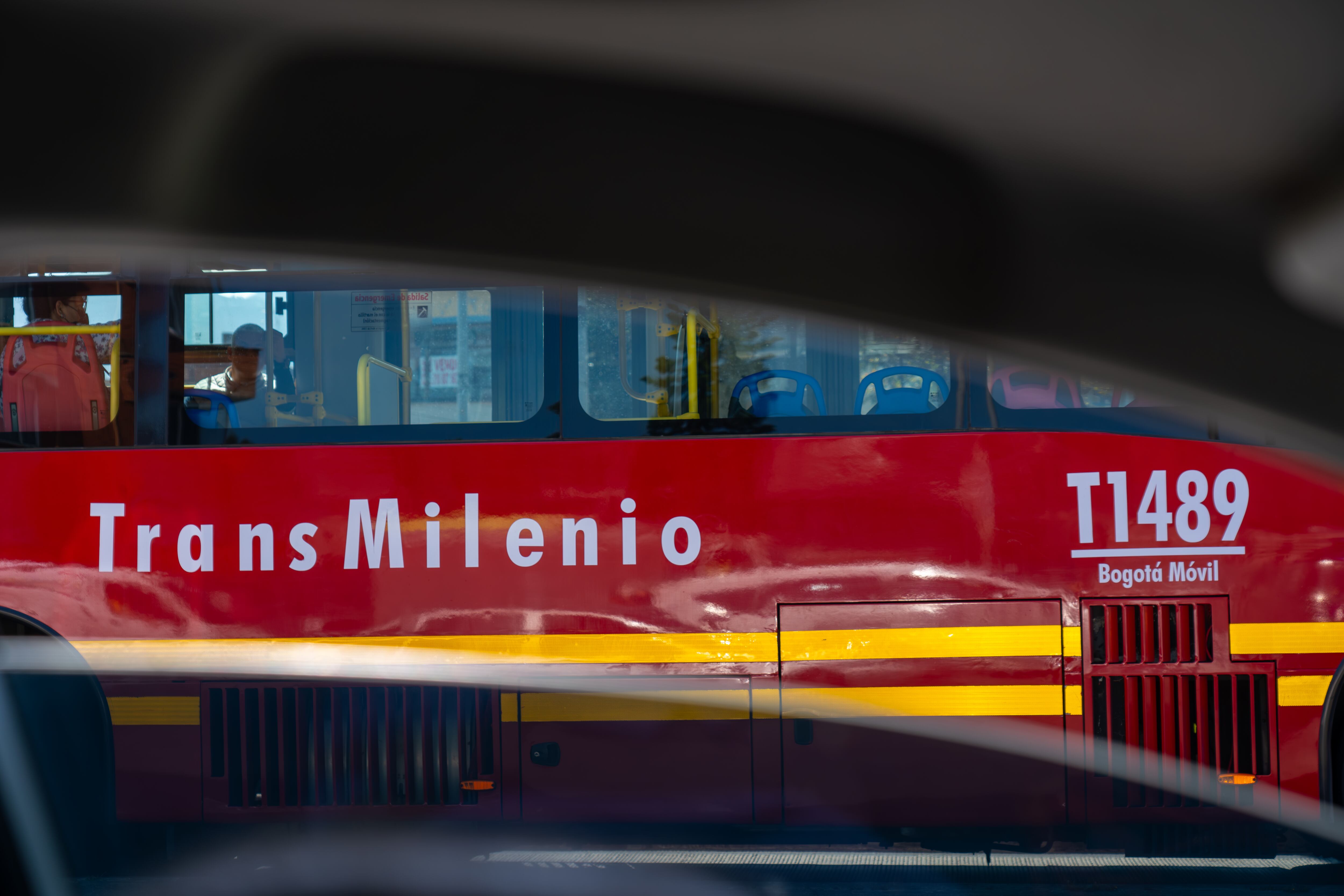 Transmilenio bus seen from a car window during daylight hours in the Colombian capital. Bogotá. Colombia. August 30, 2024.