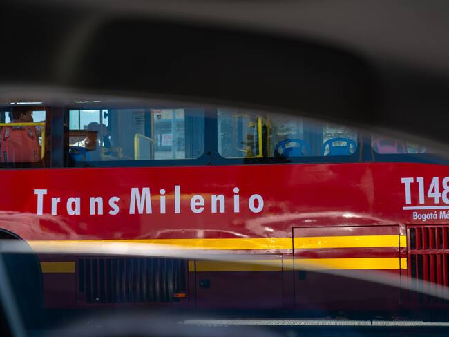 Transmilenio bus seen from a car window during daylight hours in the Colombian capital. Bogotá. Colombia. August 30, 2024.