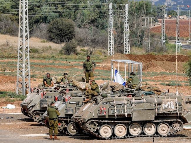 Israeli army soldiers gather by three tracked medical vehicles near the northern town of Kiryat Shmona close to the border with Lebanon on October 31, 2023 amid increasing cross-border tensions between Hezbollah and Israel as fighting continues in the south with Hamas militants in the Gaza Strip. (Photo by Jalaa MAREY / AFP) (Photo by JALAA MAREY/AFP via Getty Images)