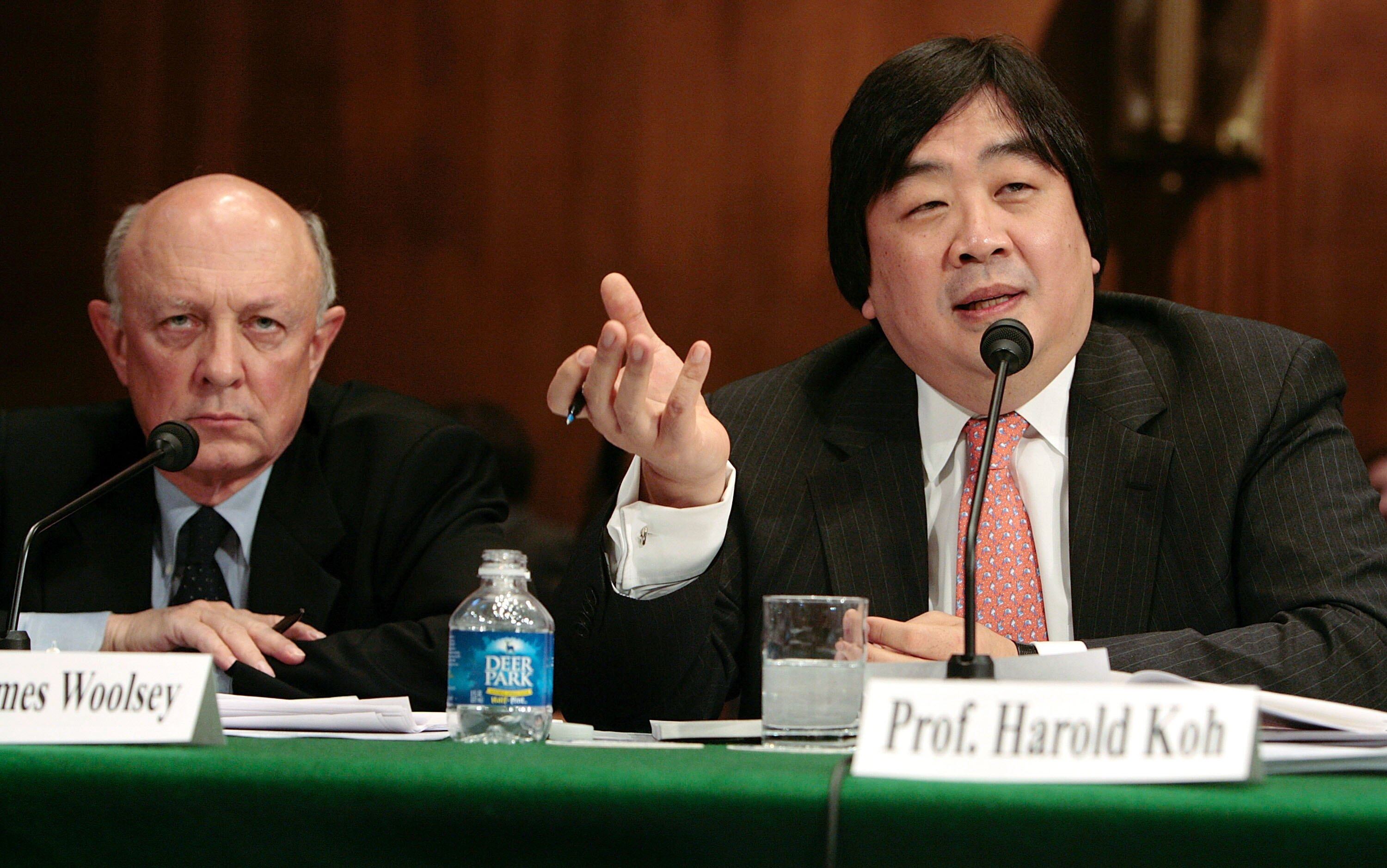 WASHINGTON - FEBRUARY 28: Former CIA Director James Woolsey (R), vice president of the Global Strategic Security Division of Booz Allen Hamilton; listens as Harold Hongju Koh (R), dean of the Yale Law School, testifies before the Senate Judiciary Committee on Capitol Hill February 28, 2006 in Washington, DC. The committee called the hearing on wartime executive power and the National Security Agency's surveillance authority. (Photo by Chip Somodevilla/Getty Images)