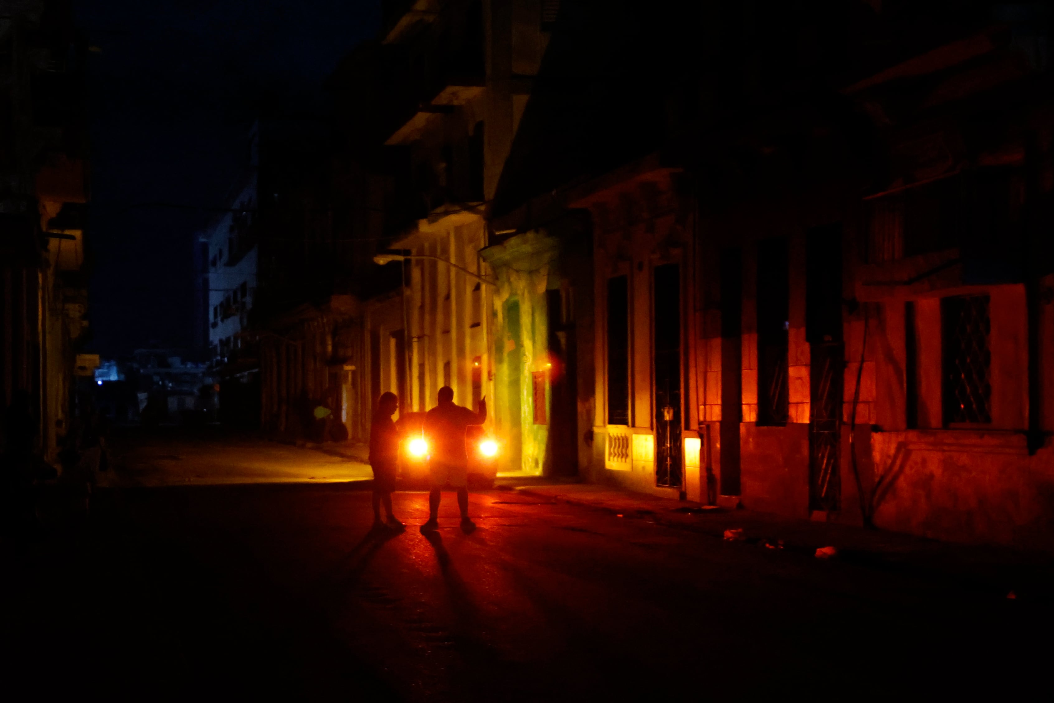 AME3505. LA HABANA (CUBA), 05/12/2024.- Una pareja habla en un sector sin servicio eléctrico a causa del tercer apagón nacional este jueves, en La Habana (Cuba). El Ministerio de Energía y Minas (Minem) de Cuba anunció el restablecimiento del Sistema Eléctrico Nacional (SEN) tras el apagón nacional del miércoles, el tercero en la isla en menos de dos meses. EFE/ Ernesto Mastrascusa