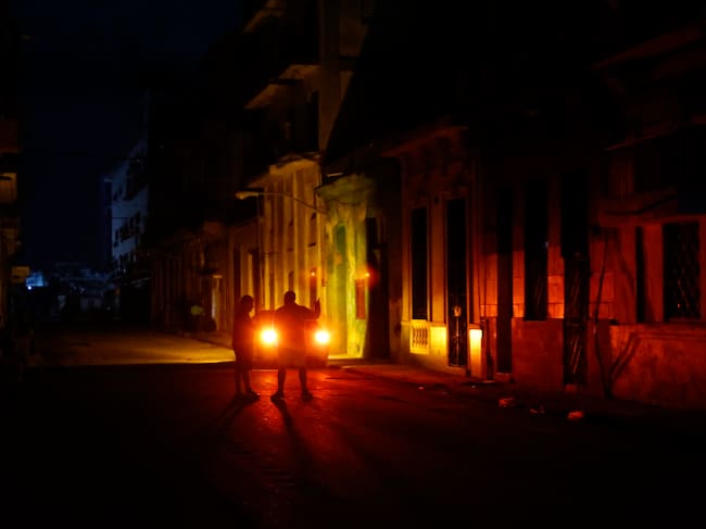 AME3505. LA HABANA (CUBA), 05/12/2024.- Una pareja habla en un sector sin servicio eléctrico a causa del tercer apagón nacional este jueves, en La Habana (Cuba). El Ministerio de Energía y Minas (Minem) de Cuba anunció el restablecimiento del Sistema Eléctrico Nacional (SEN) tras el apagón nacional del miércoles, el tercero en la isla en menos de dos meses. EFE/ Ernesto Mastrascusa