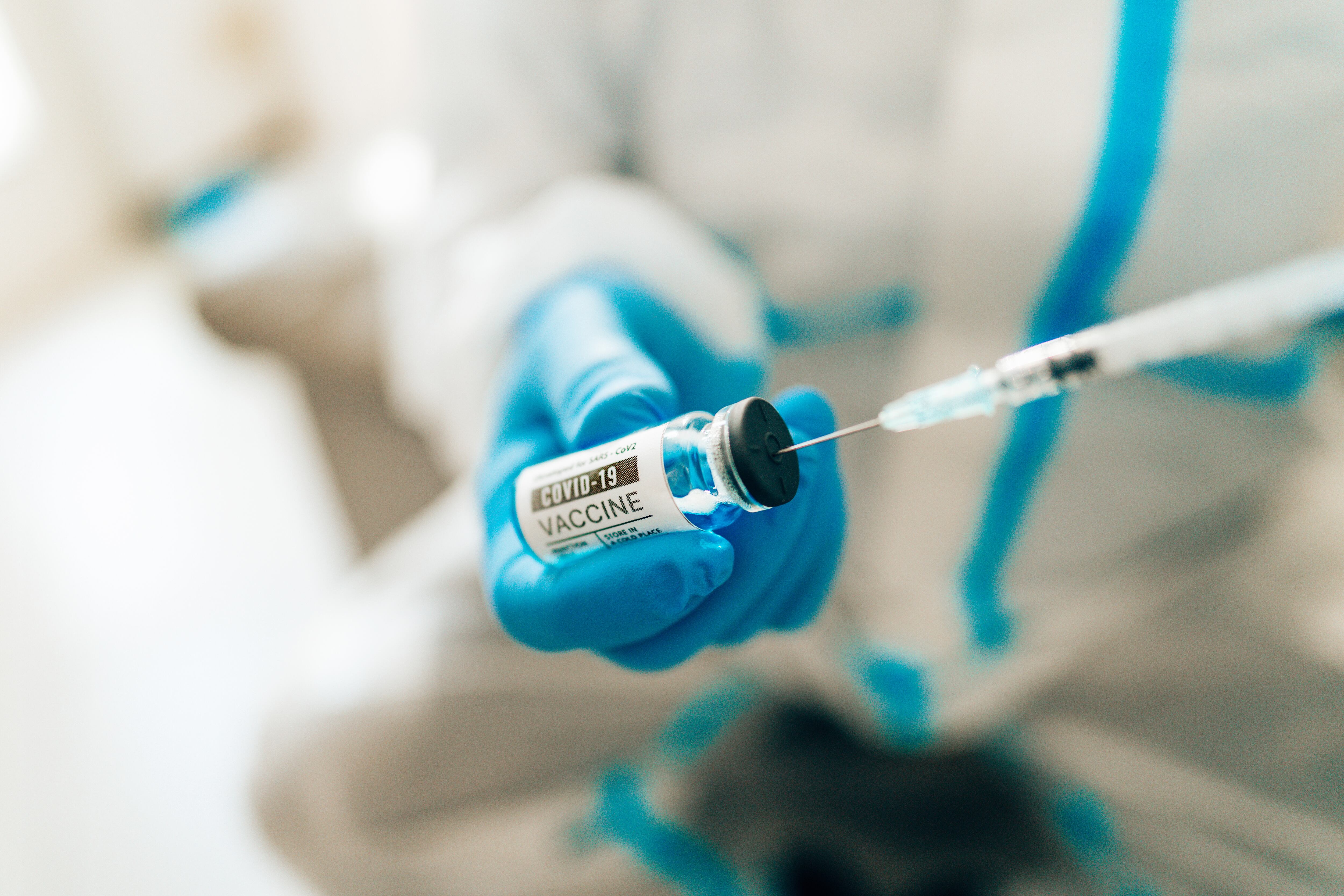 man holding a covid vax shot