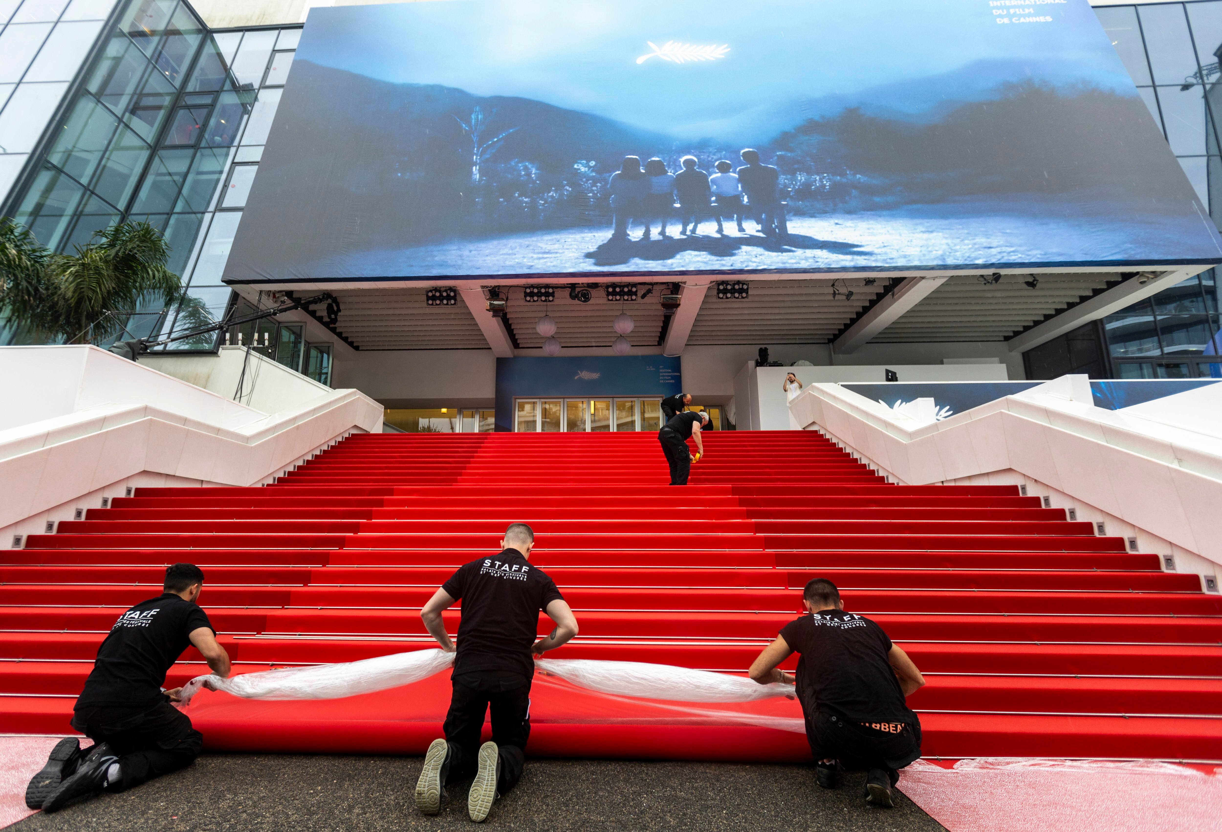 Workers install the red carpet ahead of the opening ceremony of the 77th annual Cannes Film Festival, in Cannes, France, 14 May 2024. The film festival runs from 14 to 25 May 2024. (Cine, Francia) EFE/EPA/ANDRE PAIN