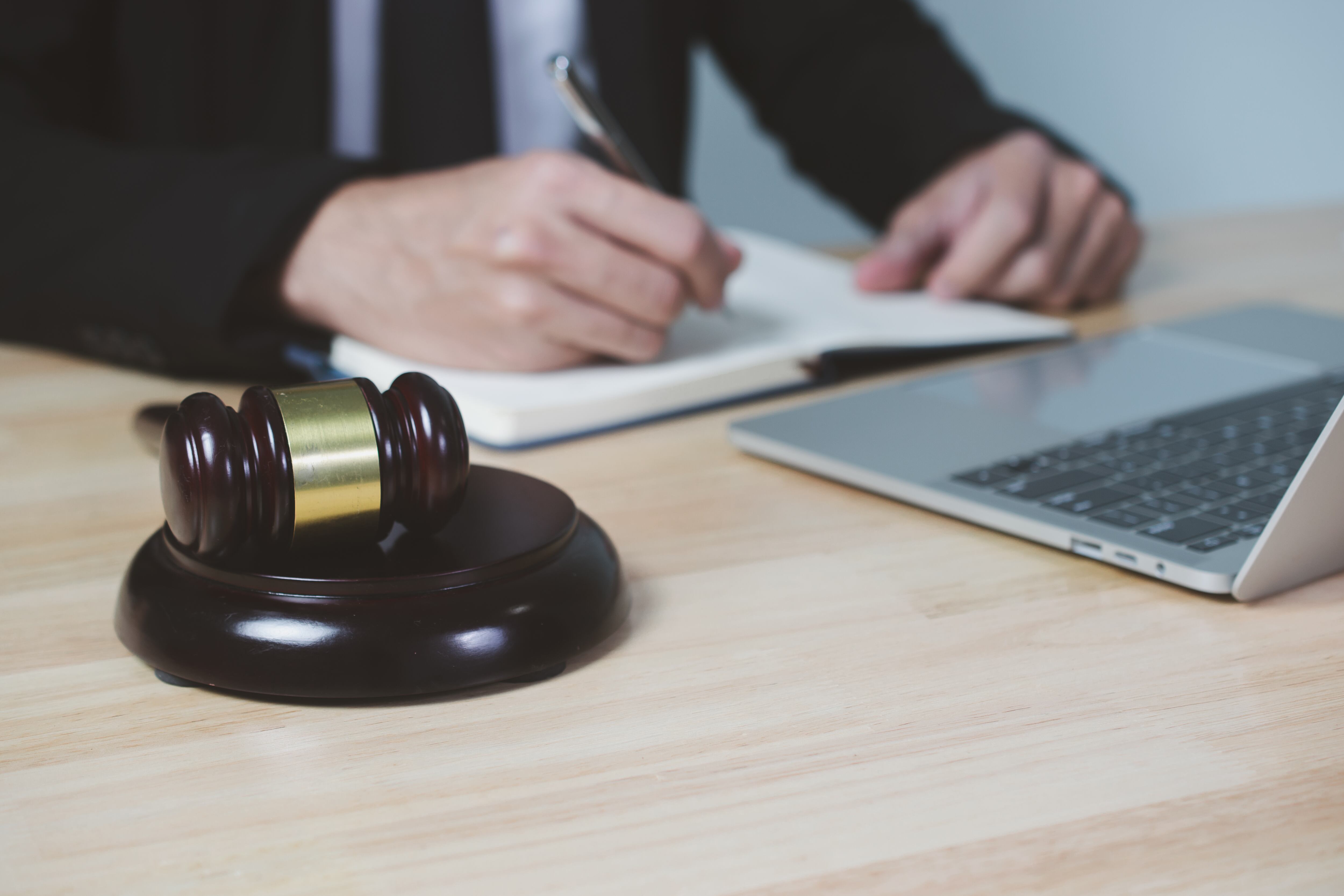 Man hand document with Judge gavel on table, closeup