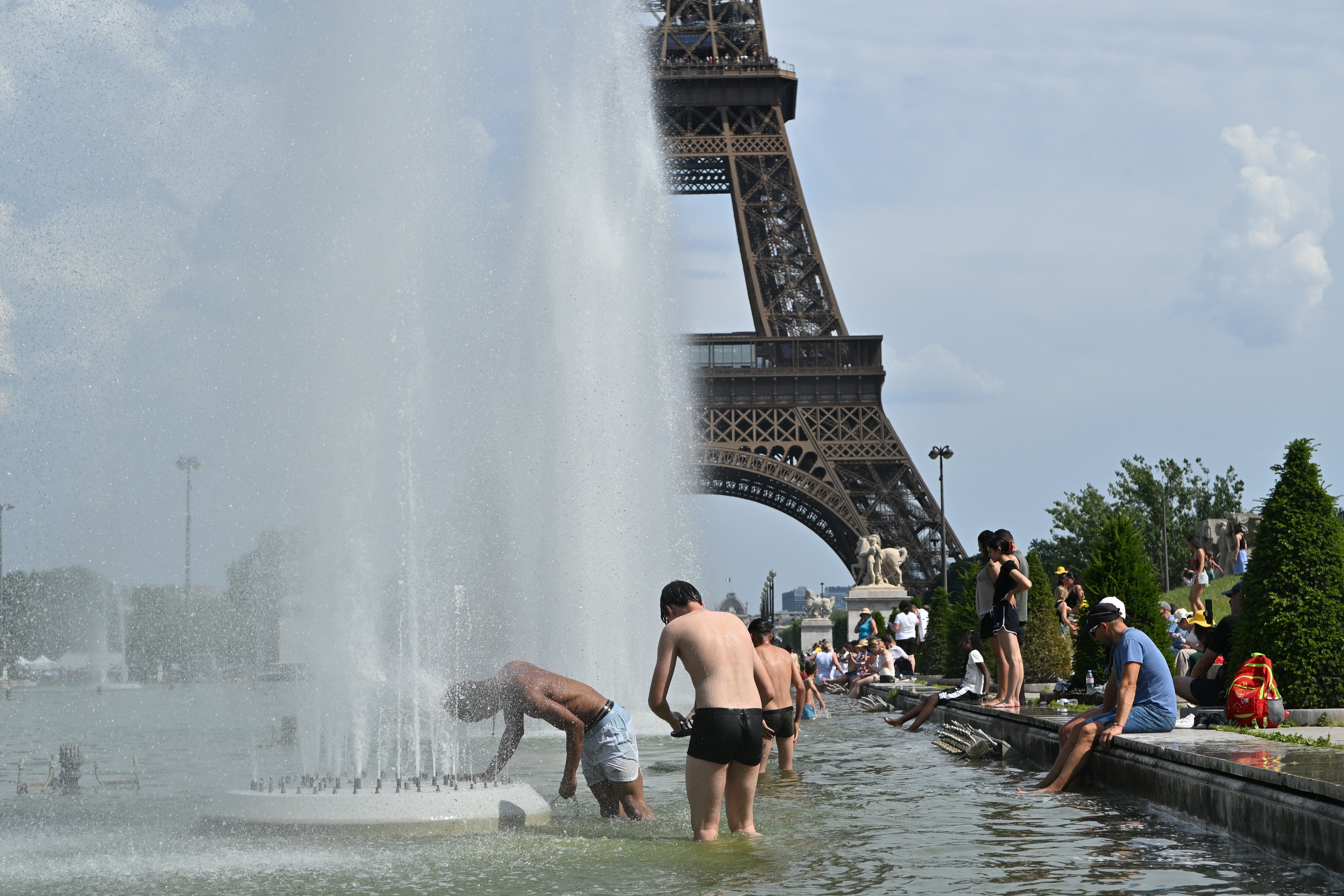 Personas bañándose en el fuentes cerca de la Torre Eiffel por ola de calor que atraviesa Francia: Getty Images.