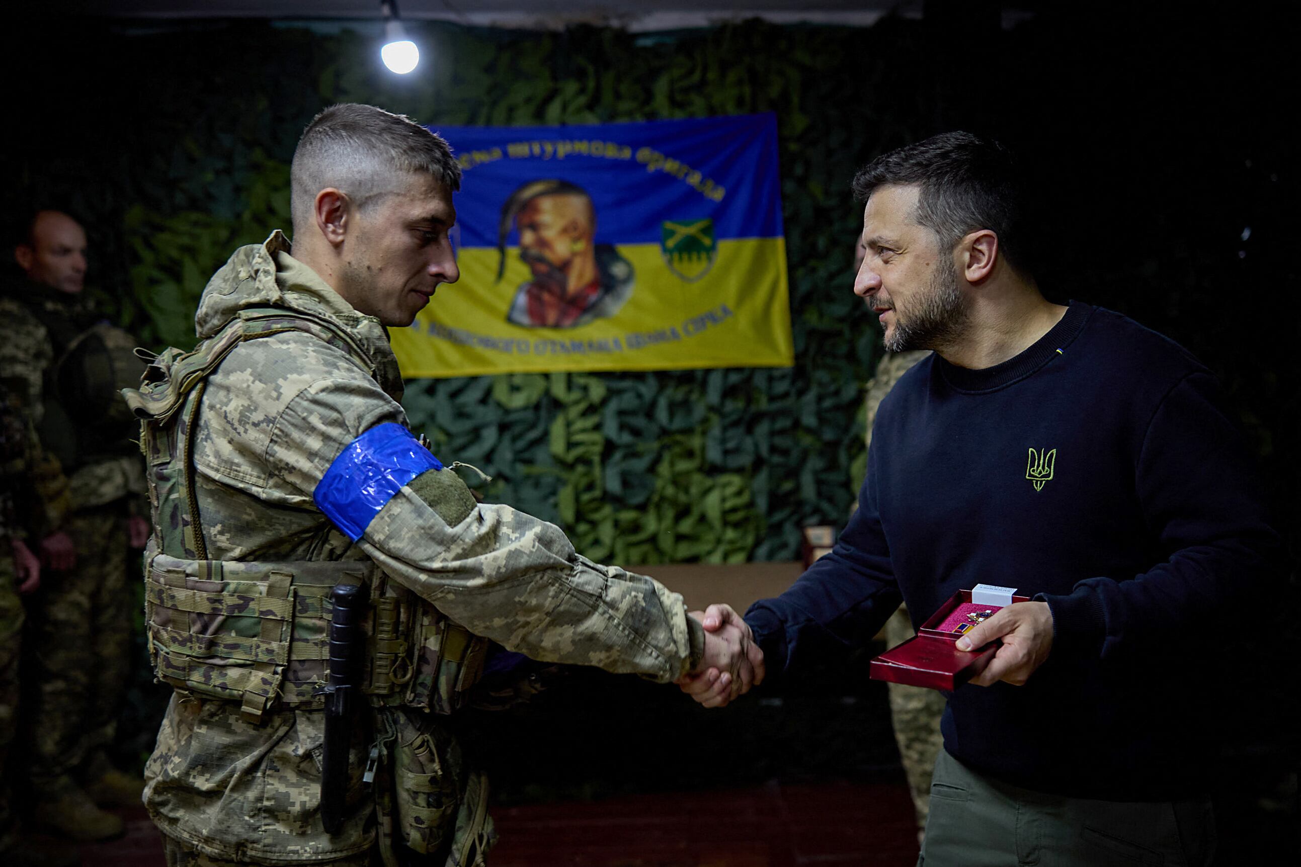 This handout photograph taken and released by the Ukrainian Presidential Press Service on May 16, 2024, shows Ukraine's President Volodymyr Zelensky (R) awarding a soldier of the 92nd separate assault brigade named after Ivan Sirko, during his visit to Kharkiv.