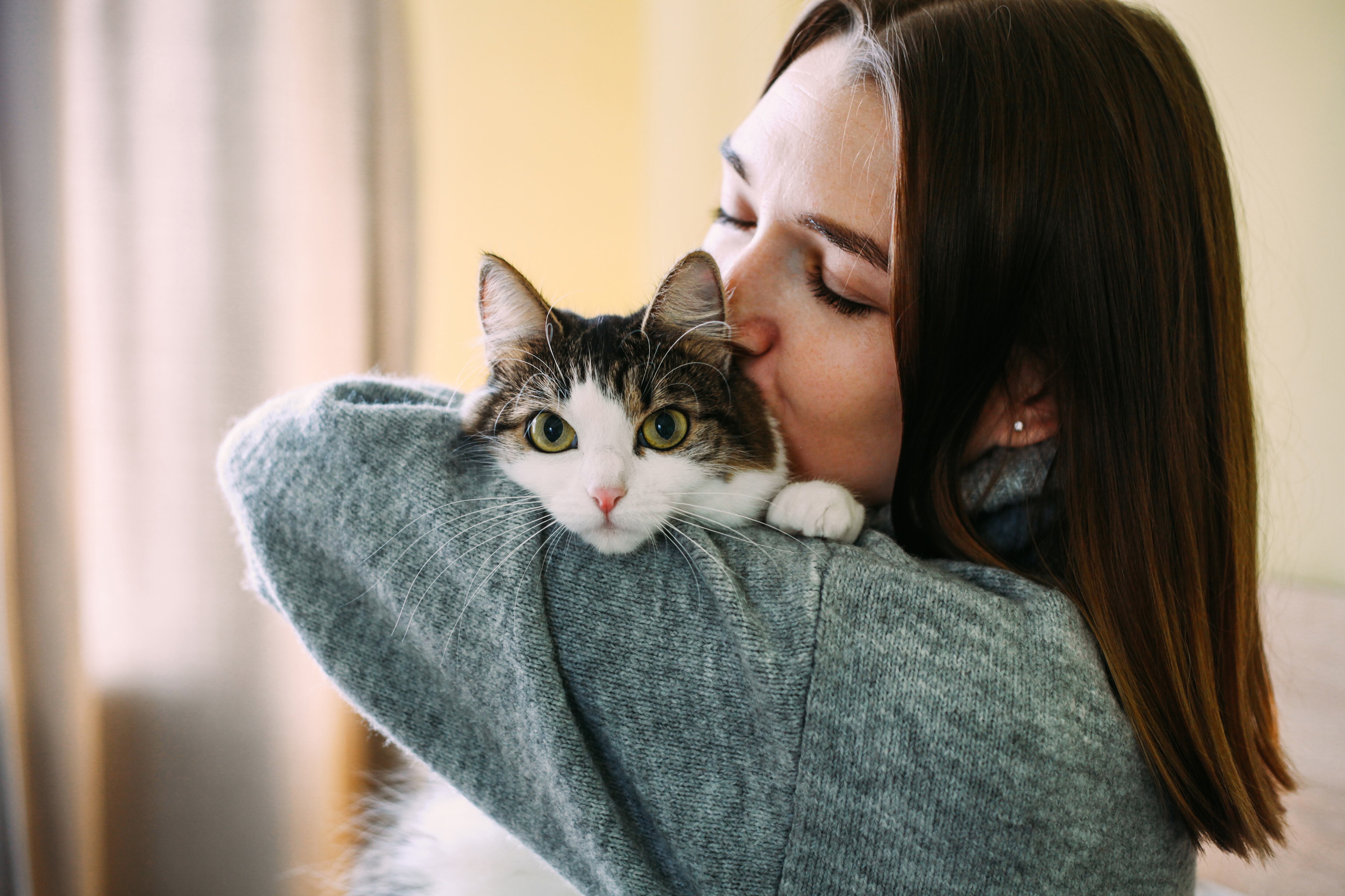 Mujer abrazando a su gato (Foto vía Getty Images).