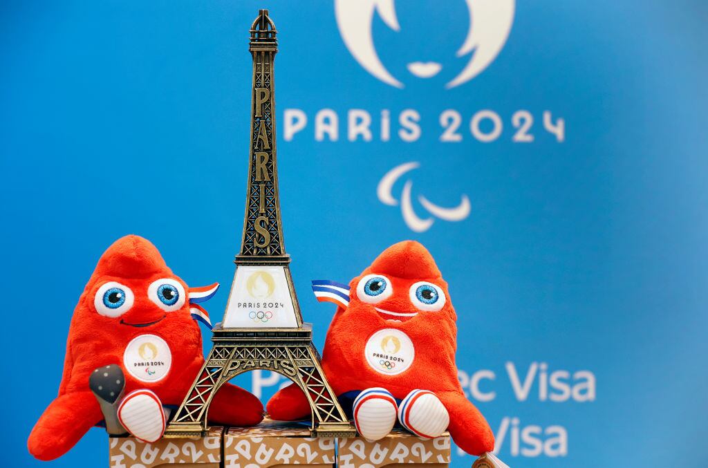A replica of the Eiffel Tower with the logo of the 2024 Olympic Games surrounded by official mascots for the Paris 2024 Summer Olympic and Paralympic Games. Photo by Chesnot/Getty Images.