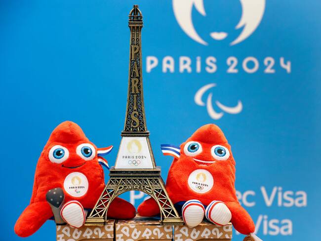 A replica of the Eiffel Tower with the logo of the 2024 Olympic Games surrounded by official mascots for the Paris 2024 Summer Olympic and Paralympic Games. Photo by Chesnot/Getty Images.