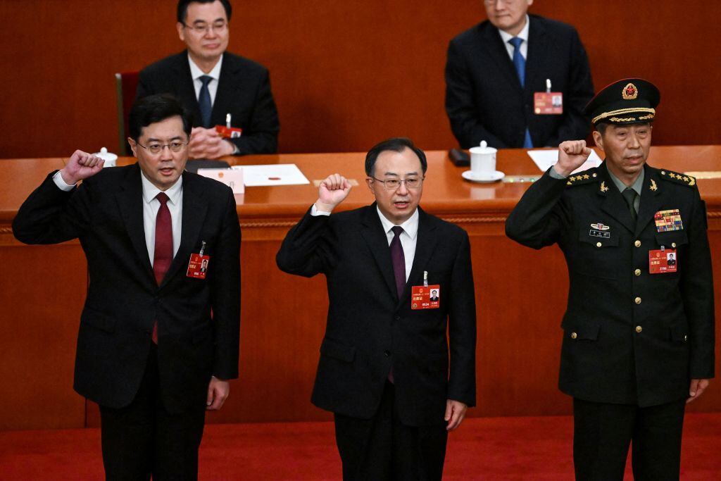 (L-R) Newly-elected Chinese state councilor Qin Gang, state councilor and secretary-general of the State Council Wu Zhenglong, state councilor Li Shangfu swear an oath after they were elected during the fifth plenary session of the National People's Congress (NPC) at the Great Hall of the People in Beijing on March 12, 2023. (Photo by NOEL CELIS / AFP) (Photo by NOEL CELIS/AFP via Getty Images)