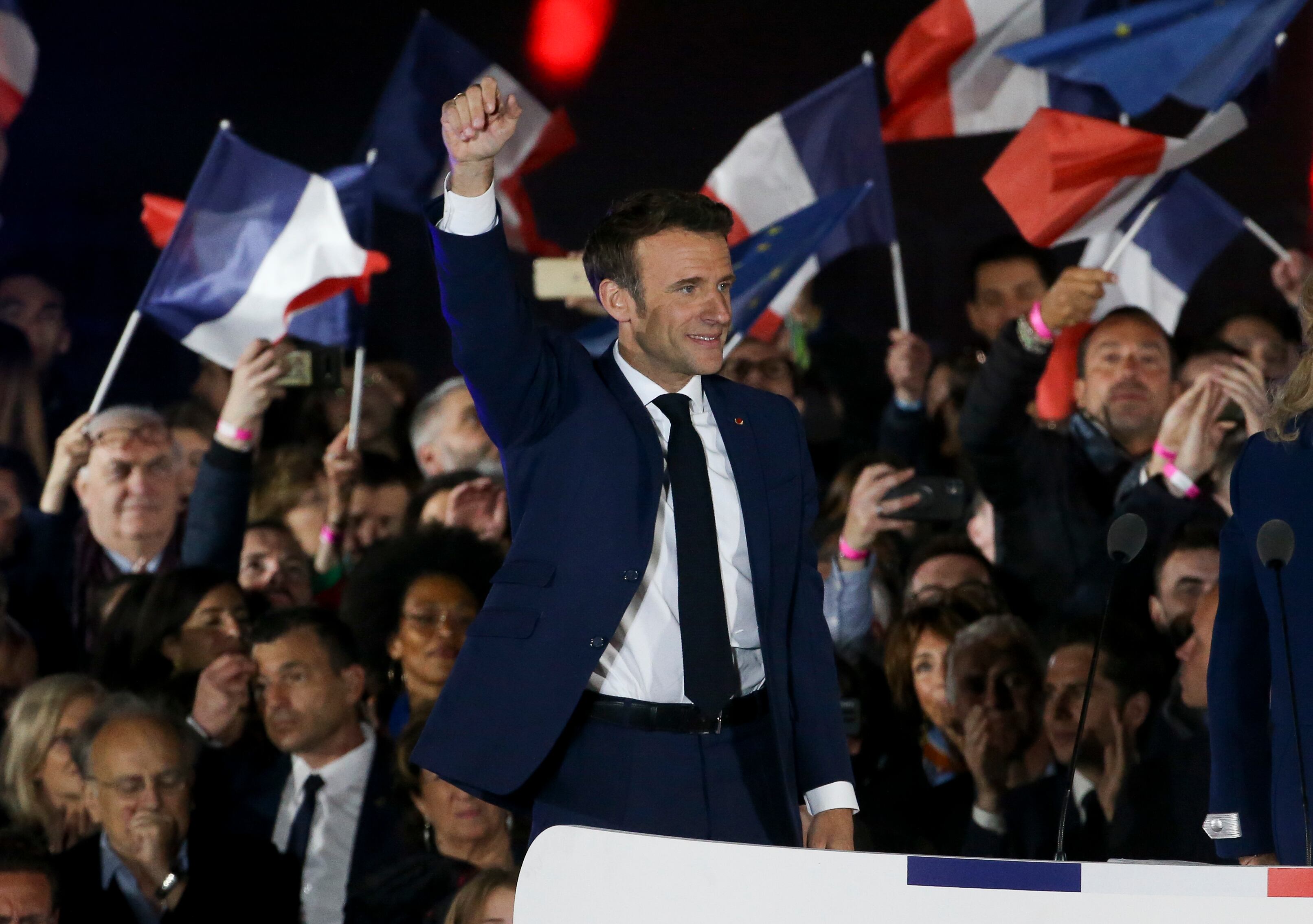 PARIS, FRANCE - APRIL 24: French President Emmanuel Macron celebrates his re-election at the Champ de Mars near the Eiffel Tower on April 24, 2022 in Paris, France. France's centrist incumbent President Emmanuel Macron beats his far-right rival Marine Le Pen in the presidential second round for a second five-year term as President. (Photo by Jean Catuffe/Getty Images)