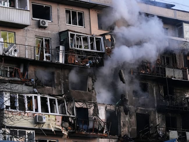Smoke comes out from a damaged residential building following an air strike in Kyiv on November 14, 2025, amid the Russian invasion of Ukraine. Almost every district in Kyiv came under "massive" attack Friday morning, the Ukrainian capital's mayor said, with a death reported hours after AFP journalists heard explosions in the city centre. (Photo by OLEKSII FILIPPOV / AFP)