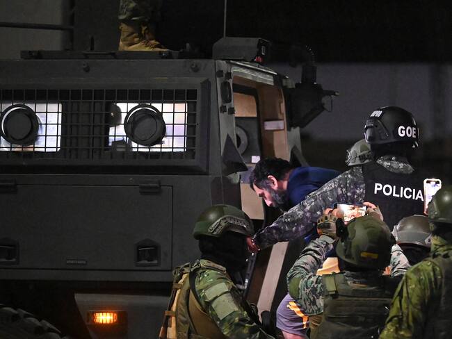 Drug trafficker Adolfo Macias (C), alias Fito, is transferred by military personnel upon arrival at the air base in Guayaquil, Ecuador, on June 25, 2025, after his recapture in Manta, Manabi Province. Ecuadorian security forces recaptured fugitive "Fito," the country's most wanted drug trafficker, whose escape in January 2024 sparked an unprecedented wave of violence, President Daniel Noboa reported on June 25. (Photo by MARCOS PIN / AFP) (Photo by MARCOS PIN/AFP via Getty Images)