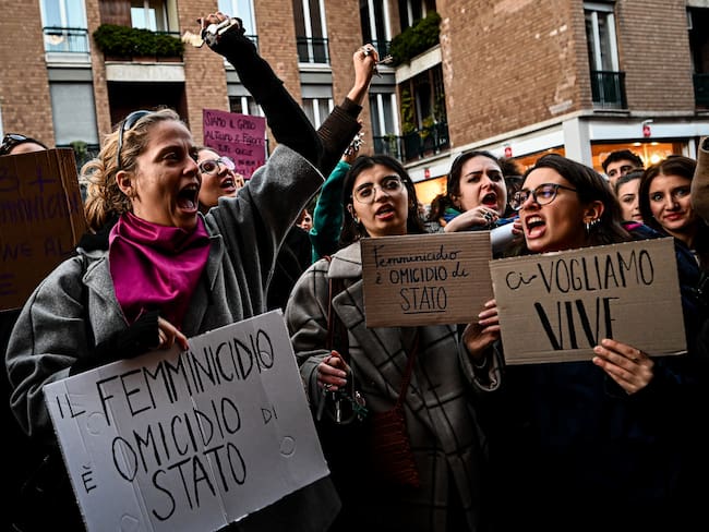 Protesters hold placards reading 'Femicide is a state homicide' and 'We want us alive' outside the University of Milan during a demonstration following the suspected feminicide of 22-year-old Giulia Cecchettin, in Milan, on November 22, 2023. A court in Germany said on November 22 it has approved the extradition of a 22-year-old Italian university student arrested in Germany for allegedly kidnapping and killing his former girlfriend. The suspect's lawyer had identified him as Filippo Turetta, who went missing more than a week ago along with his fellow student and former girlfriend Giulia Cecchettin. In the year to November 12, there have been 102 murder cases with female victims in Italy, 82 of whom were killed by family members or current or former partners, according to the interior ministry. (Photo by Piero CRUCIATTI / AFP)