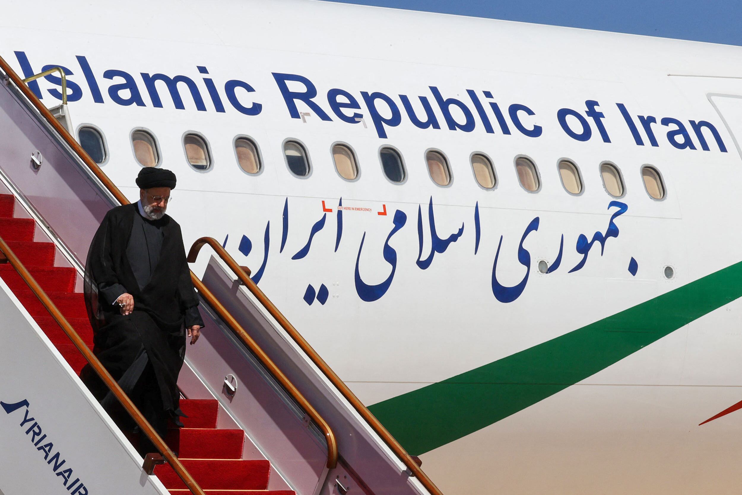 This handout picture released by the Iranian Presidency shows, Iranian President Ebrahim Raisi leaving his aeroplane after landing at Damascus International Airport on May 3, 2023. Raisi arrived in Damascus today for the first visit by an Iranian president since Syria's civil war broke out, state media reported, as regional engagement with the two allies expands. (Photo by Iranian Presidency / AFP) / RESTRICTED TO EDITORIAL USE - MANDATORY CREDIT "AFP PHOTO / IRANIAN PRESIDENCY  " - NO MARKETING NO ADVERTISING CAMPAIGNS - DISTRIBUTED AS A SERVICE TO CLIENTS