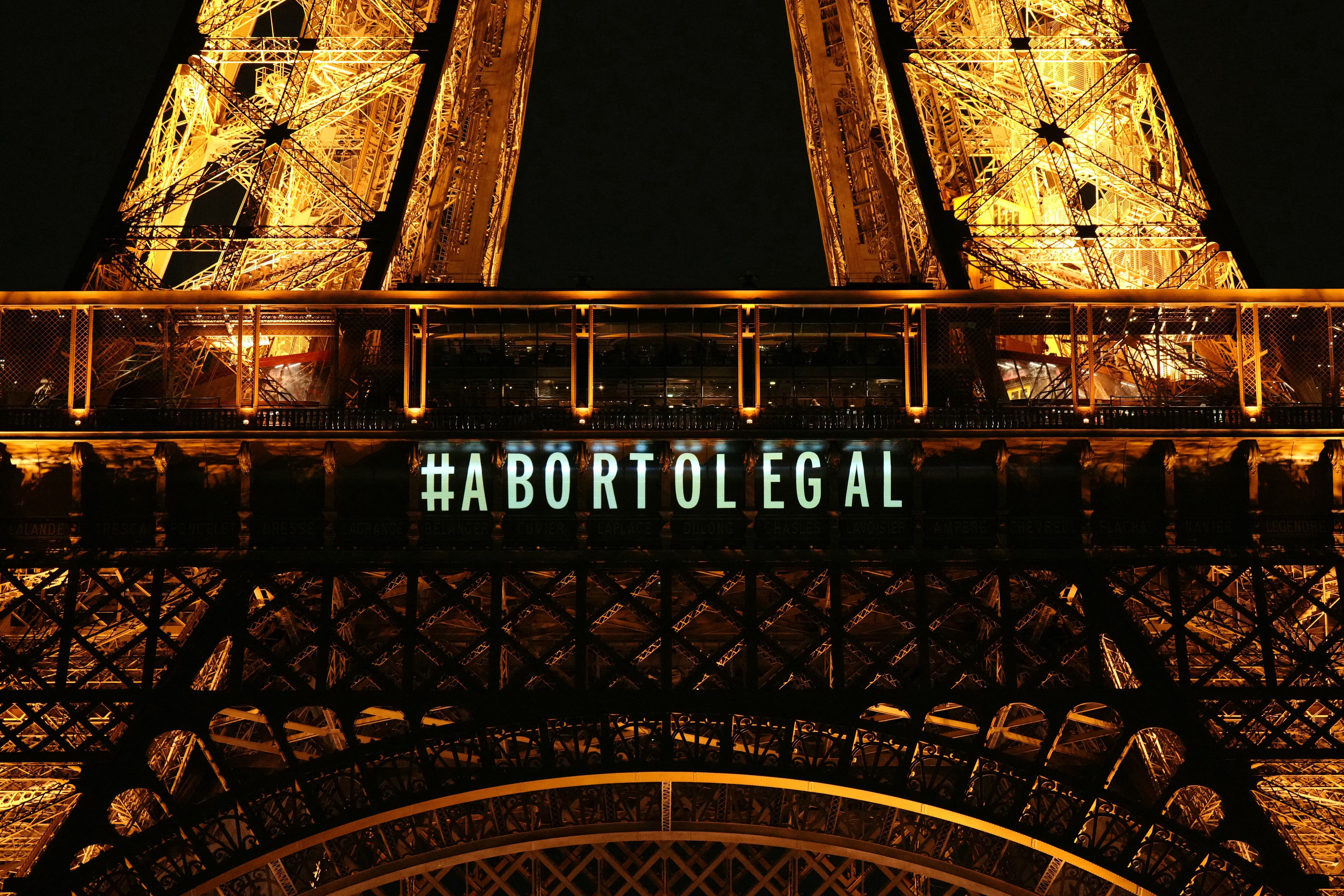 A message reading in Spanish "Abortion legal" is projected onto the Eiffel Tower after the French parliament voted to anchor the right to abortion in the country's constitution, in Paris, on March 4, 2024. (Photo by Dimitar DILKOFF / AFP)