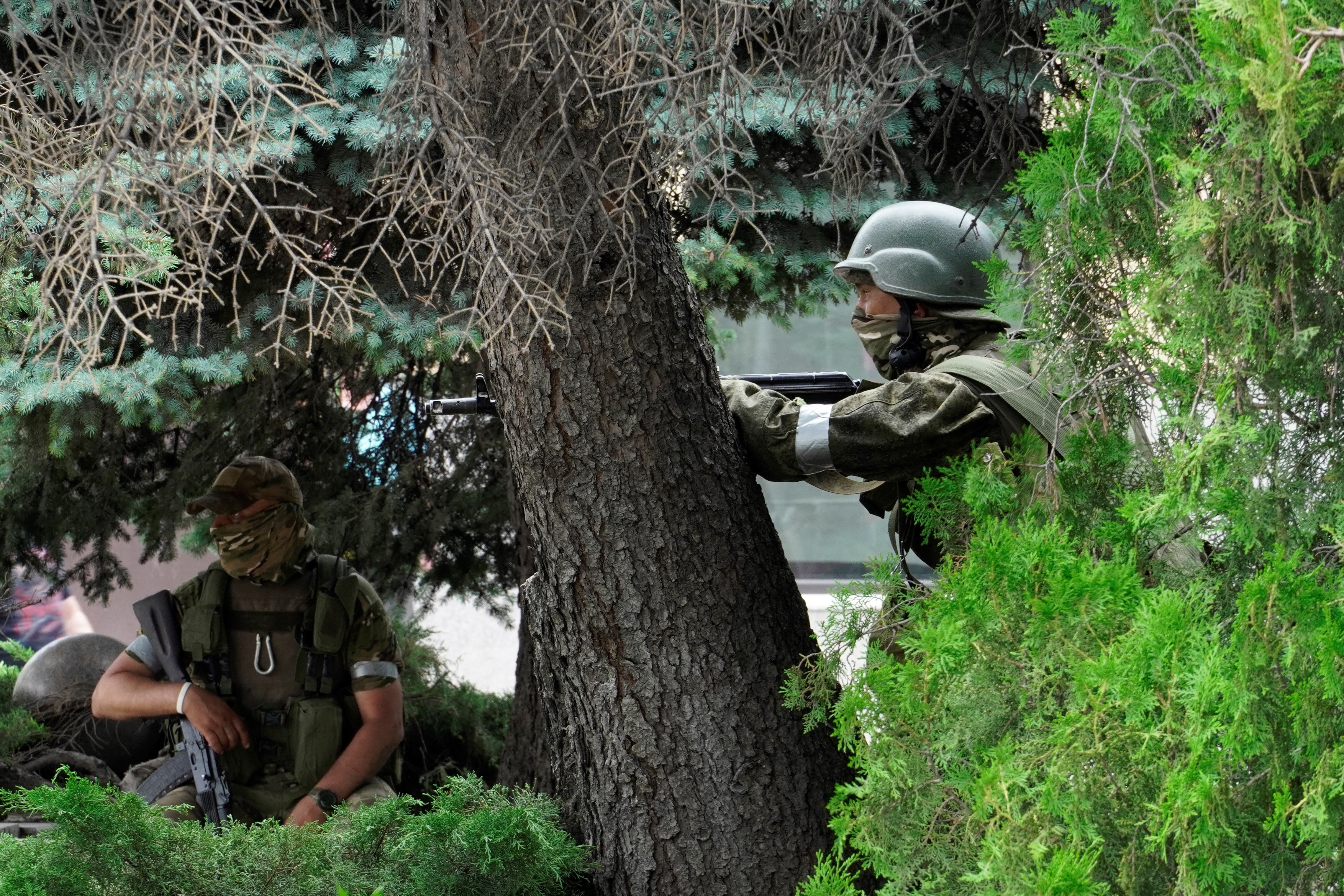 Members of Wagner group stand guard in a street in the city of Rostov-on-Don, on June 24, 2023.  (Photo by STRINGER / AFP)