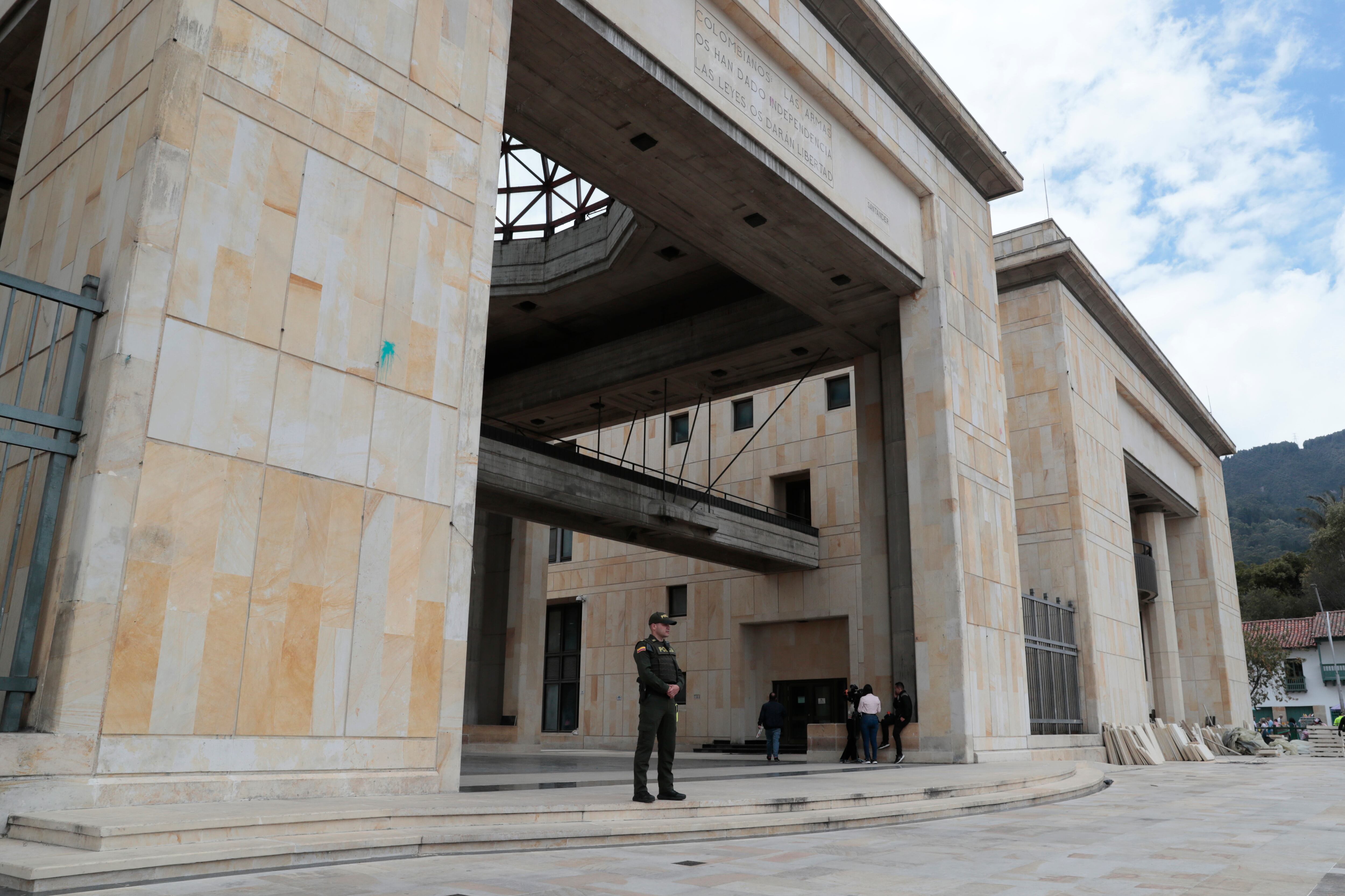 AME936. BOGOTÁ (COLOMBIA), 16/08/2024.- Un integrante de la Policía de Colombia vigila una de las entradas de la Corte Suprema este viernes, en Bogotá (Colombia). El Gobierno colombiano ordenó reforzar la seguridad de la Corte Suprema de Justicia y de otras sedes judiciales del país después de la alerta de seguridad emitida por la Policía al hallar, en un operativo de Bogotá, explosivos y una maqueta del Palacio de Justicia de la capital. EFE/ Carlos Ortega